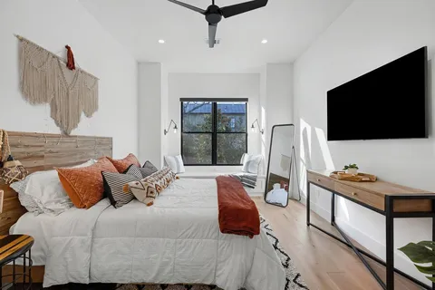 a bedroom with a bed and a flat screen tv