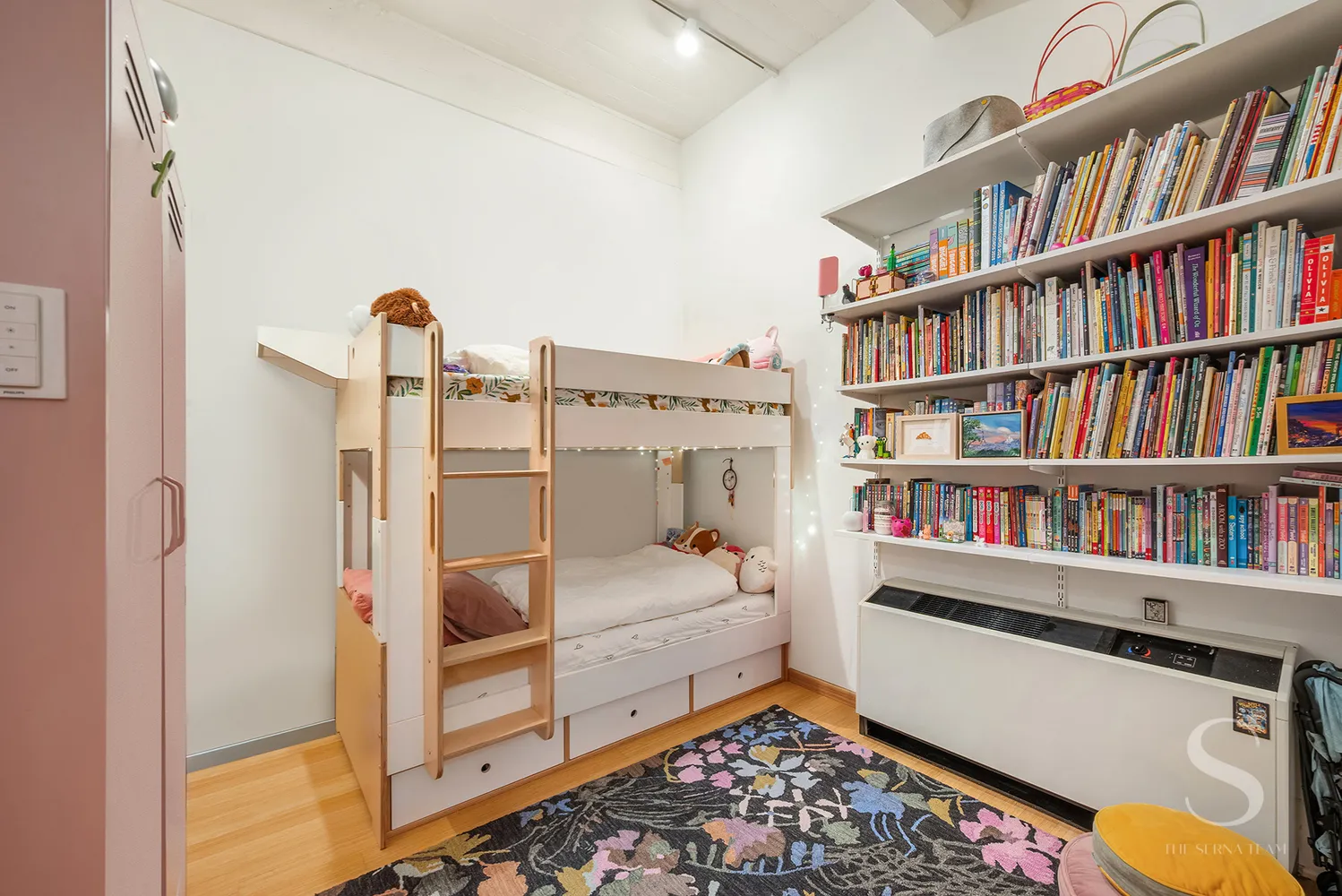 a bed room with a bed and a book shelf