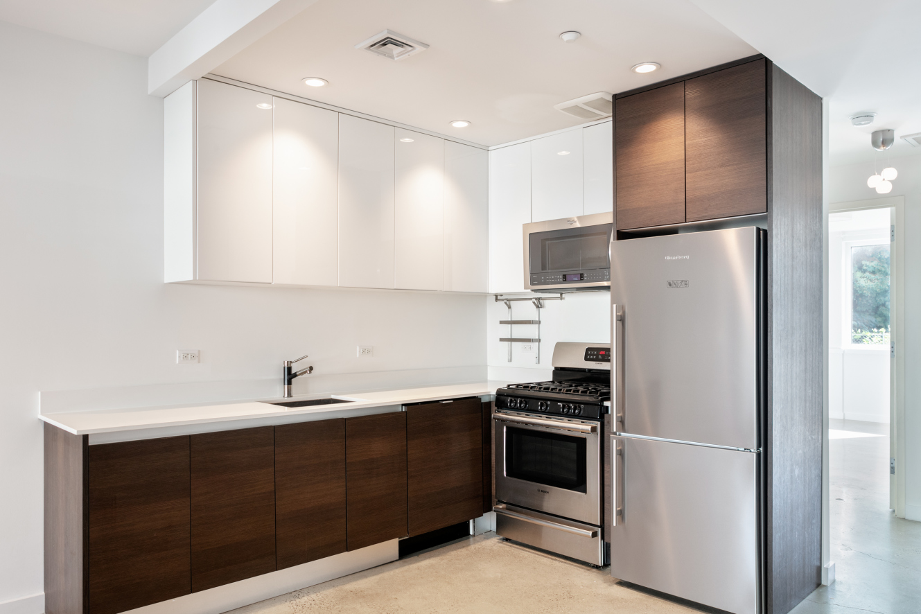 834 Sterling Place, Unit 203 Brooklyn, NY 11216 - Photo 3 of 12 a kitchen with a refrigerator sink and cabinets