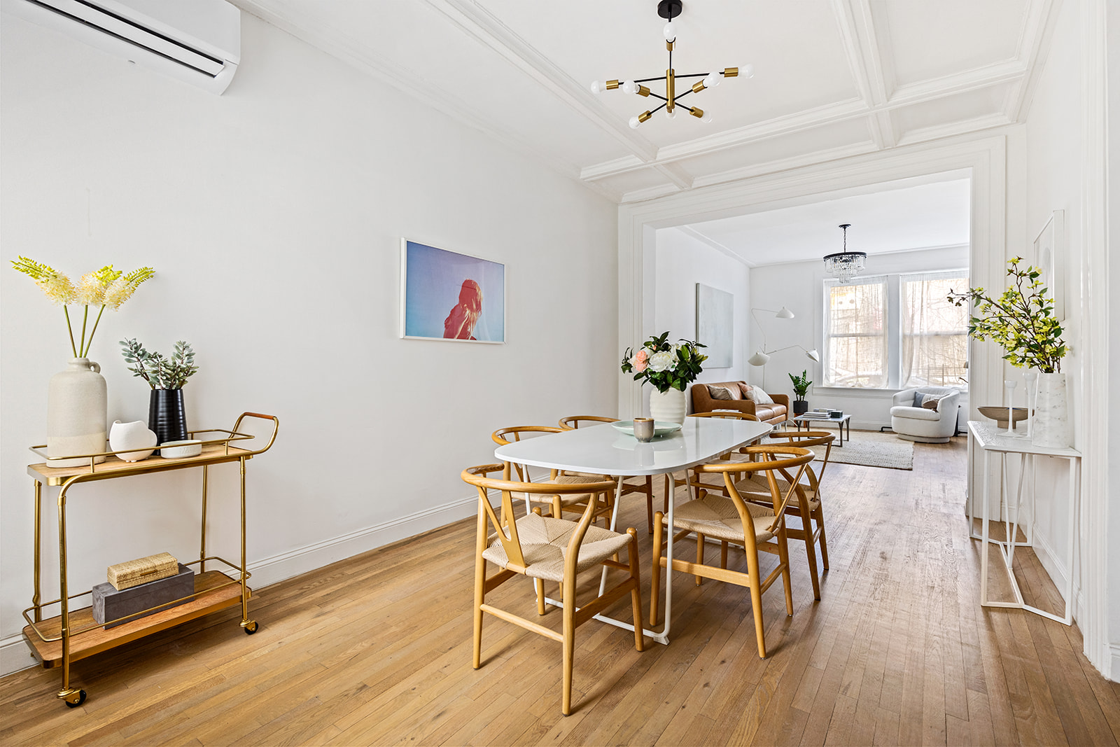 a view of a dining room with furniture and wooden floor