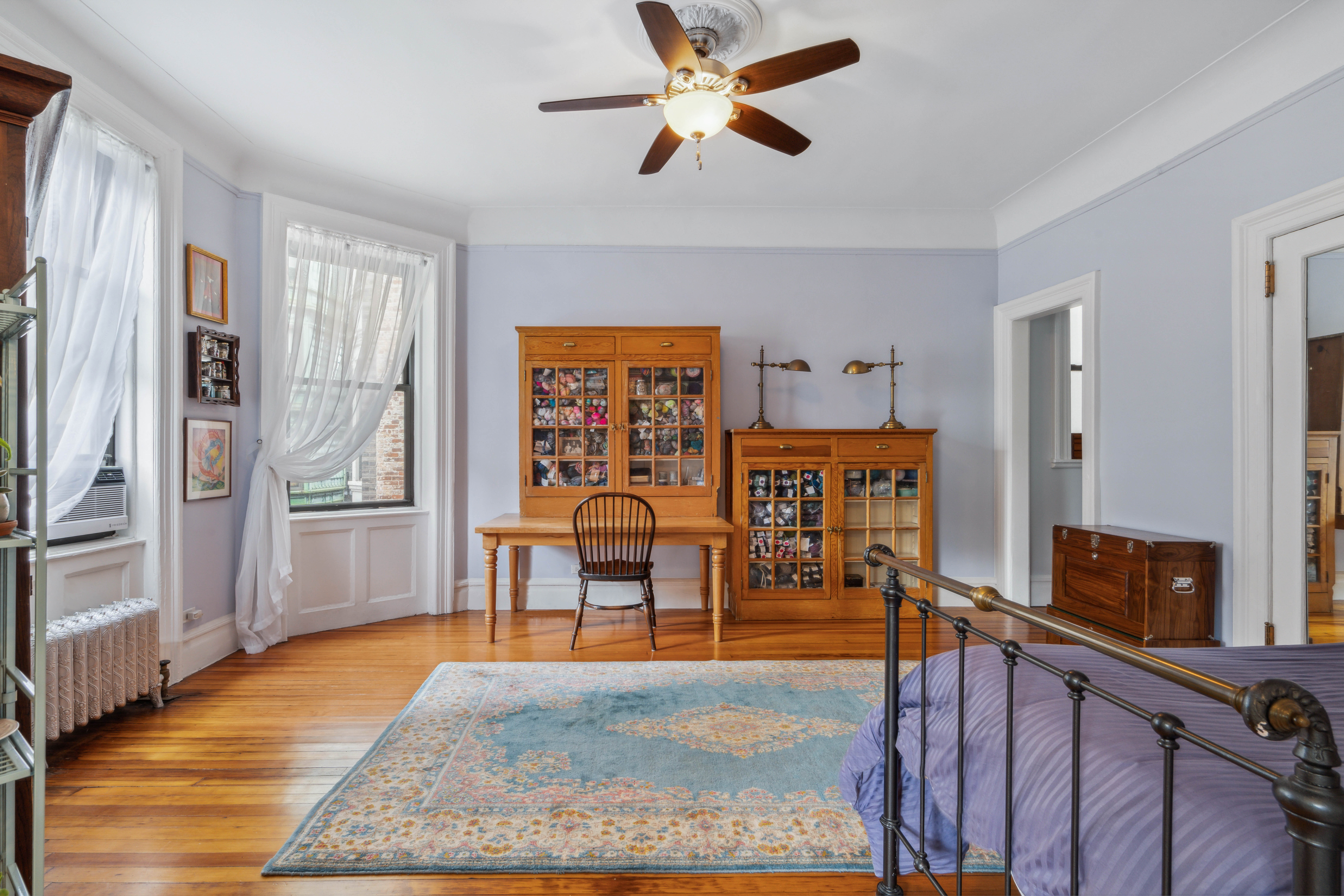 194 Riverside Drive, Unit 4B Manhattan, NY 10025 - Photo 5 of 17 a view of a livingroom with furniture hardwood floor and a ceiling fan