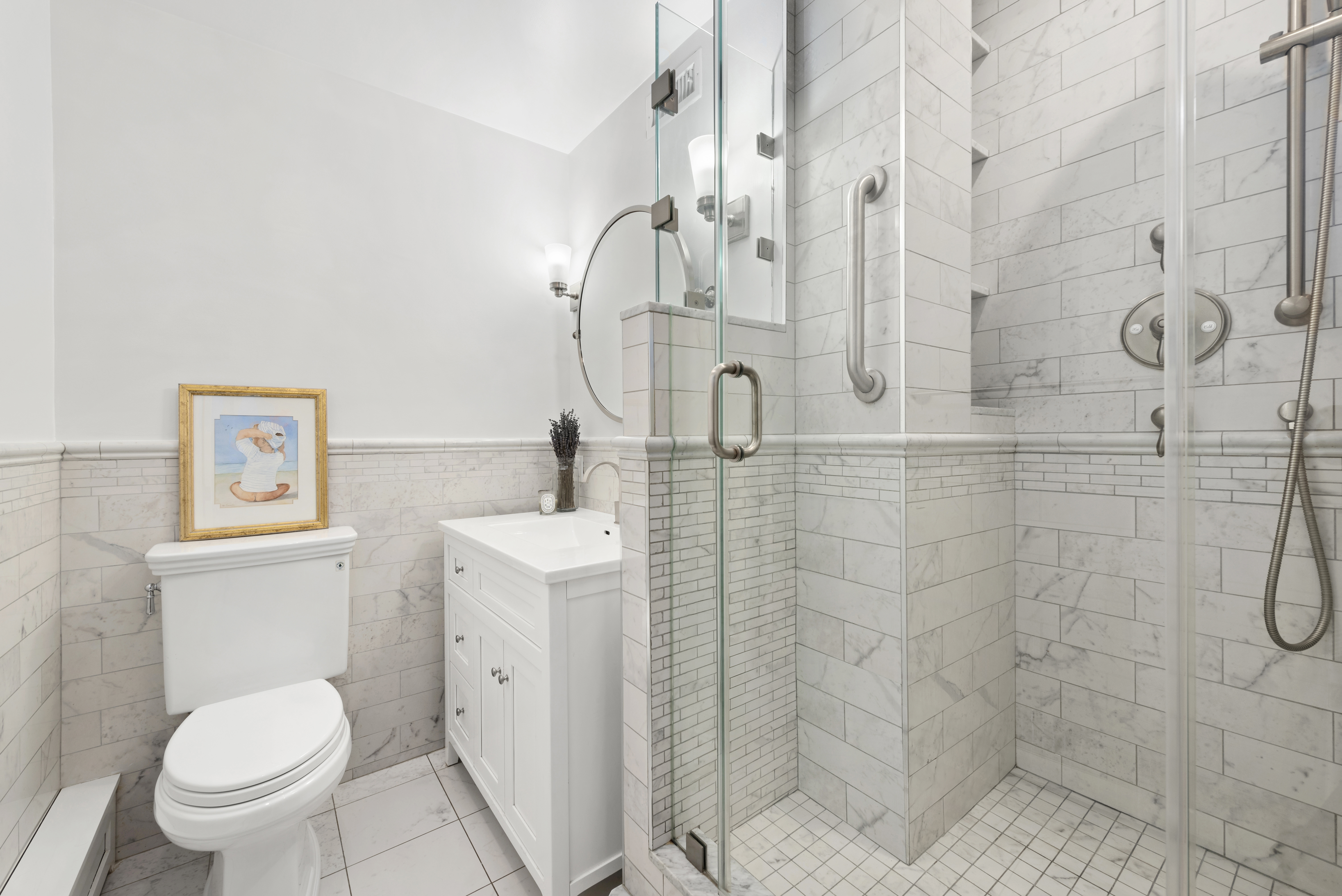 153 East 87th Street, Unit 6D Manhattan, NY 10128 - Photo 6 of 8 a bathroom with a toilet sink and shower