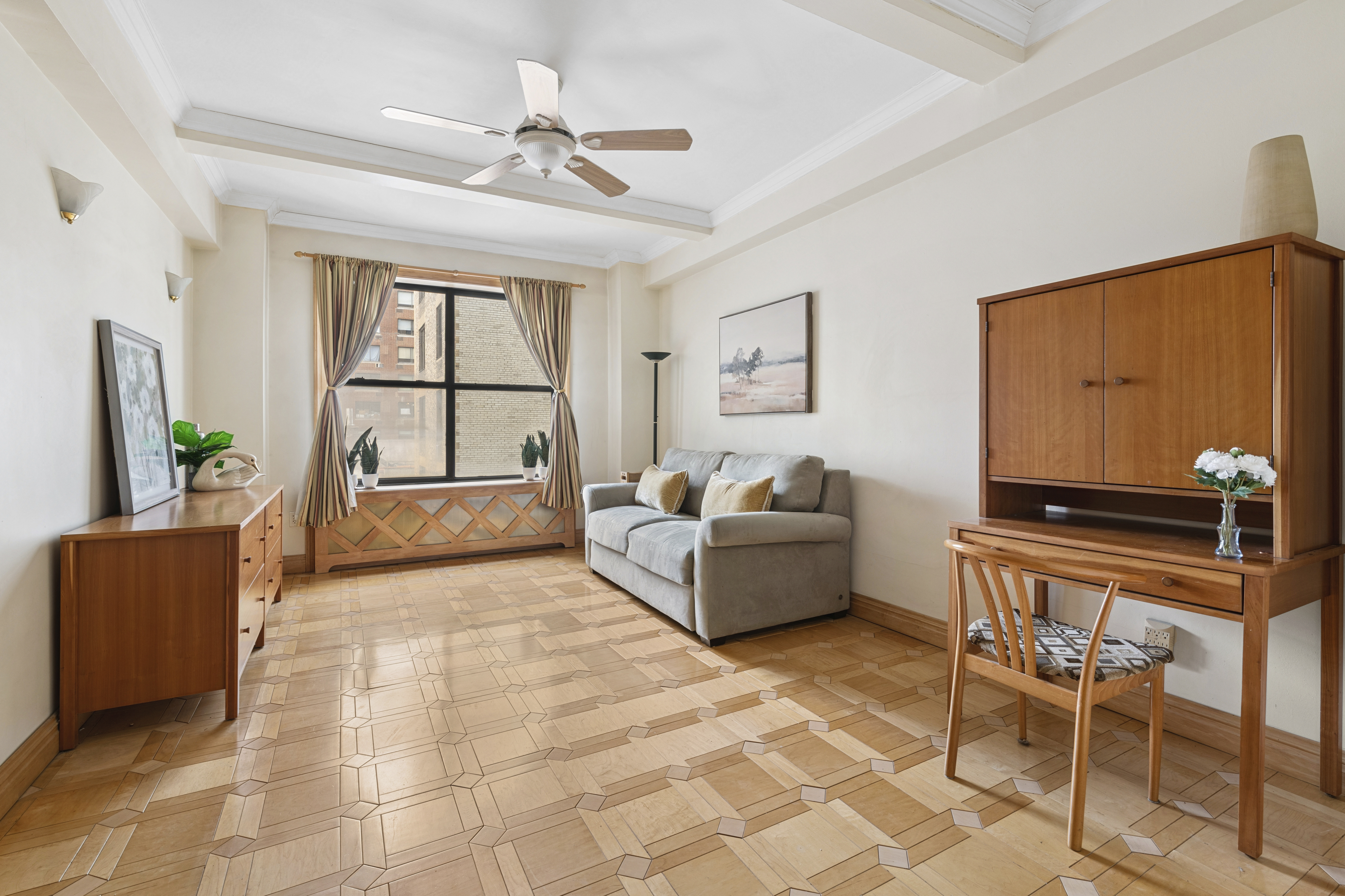 225 Central Park West, Unit 916 Manhattan, NY 10024 - Photo 3 of 13 a living room with furniture and a flat screen tv