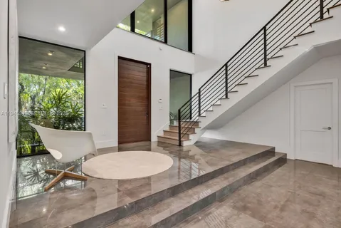 a view of entryway and hall with wooden floor