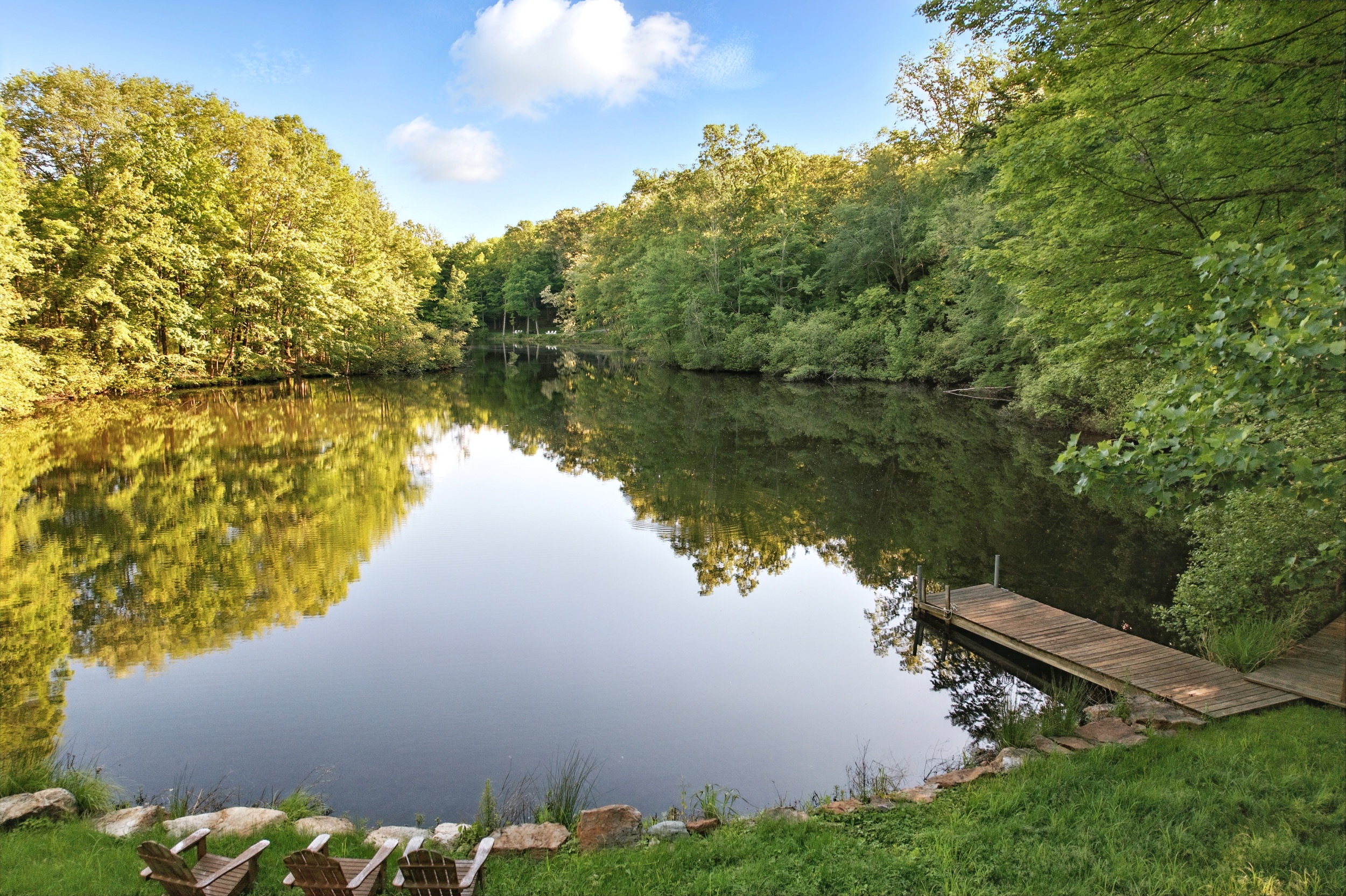 19 Pond Road Cold Spring, NY 10516 - Photo 26 of 32 a view of a lake with a yard and large trees