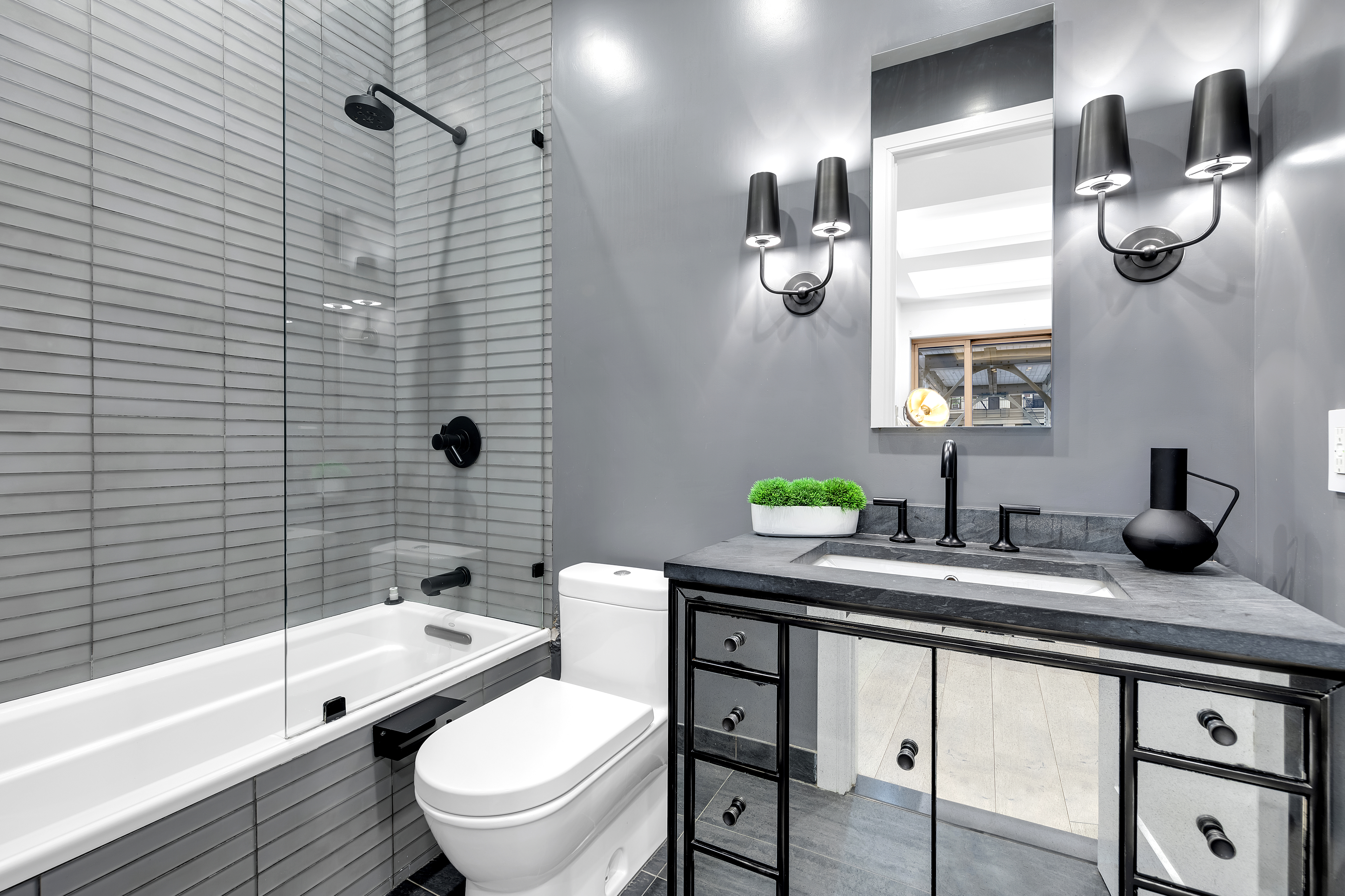 106 Central Park South, Unit 2B Manhattan, NY 10019 - Photo 8 of 12 a bathroom with a granite countertop sink a toilet and shower