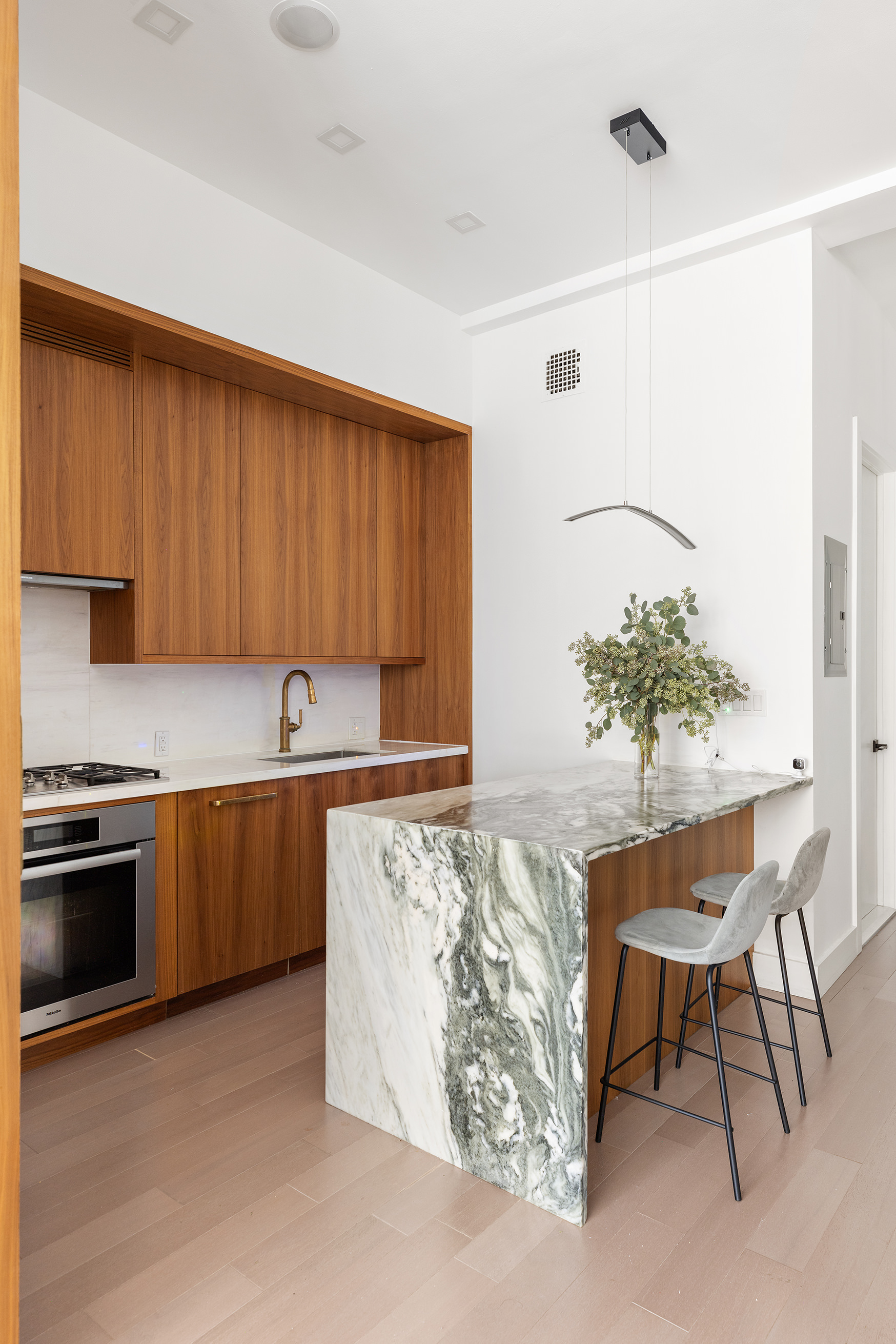 21 East 22nd Street, Unit 2A Manhattan, NY 10010 - Photo 4 of 10 a kitchen with stainless steel appliances granite countertop a sink and a stove