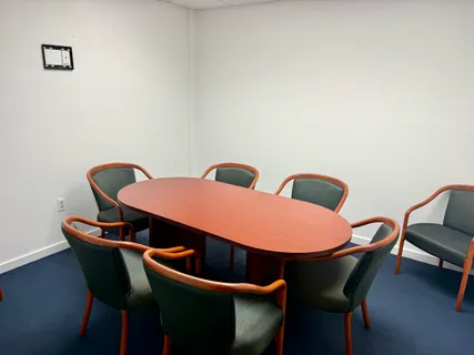 a view of a room with table and chairs