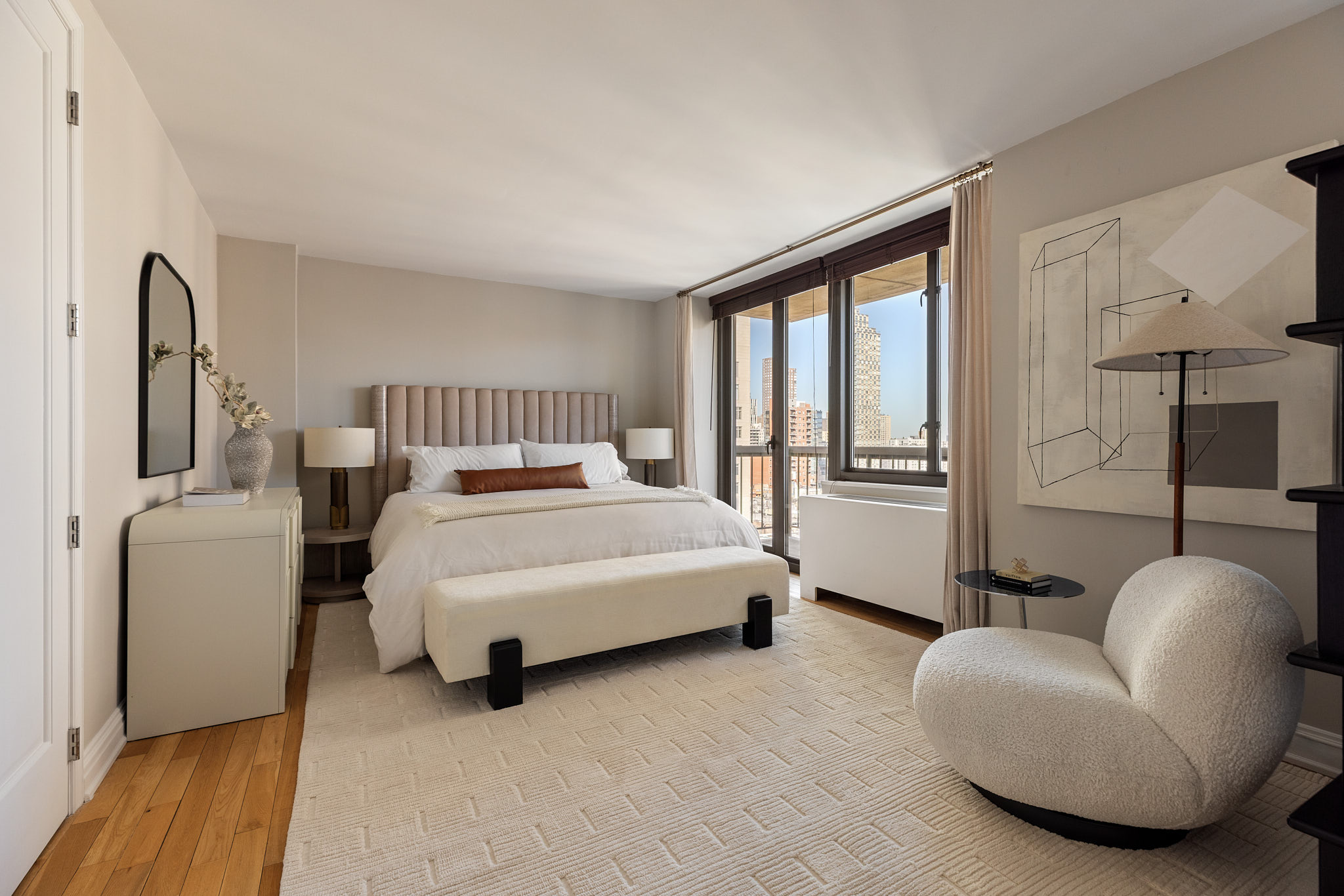1438 3rd Avenue, Unit 15B Manhattan, NY 10028 - Photo 11 of 21 a bed room with a bed and a couch
