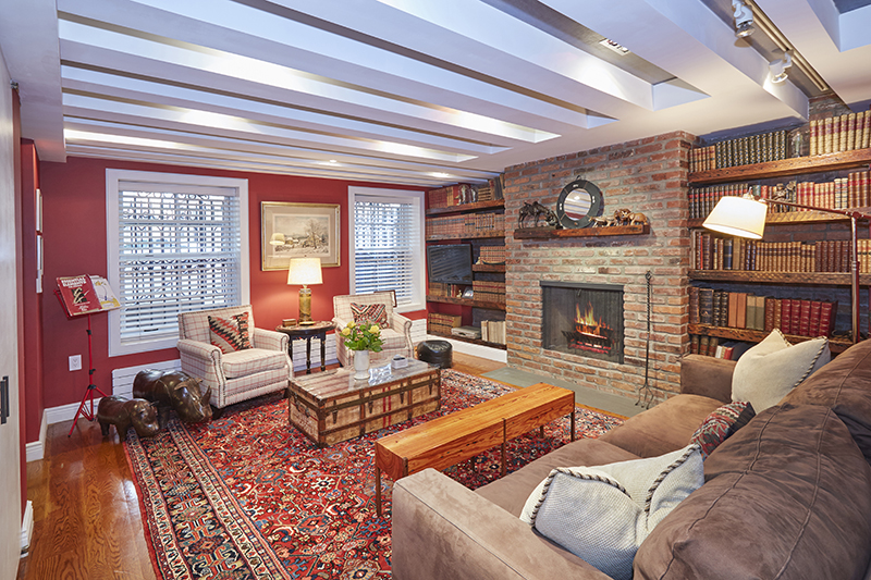 308 West 19th Street, Unit GARDEN Manhattan, NY 10011 - Photo 14 of 18 a living room with furniture a fireplace and a flat screen tv