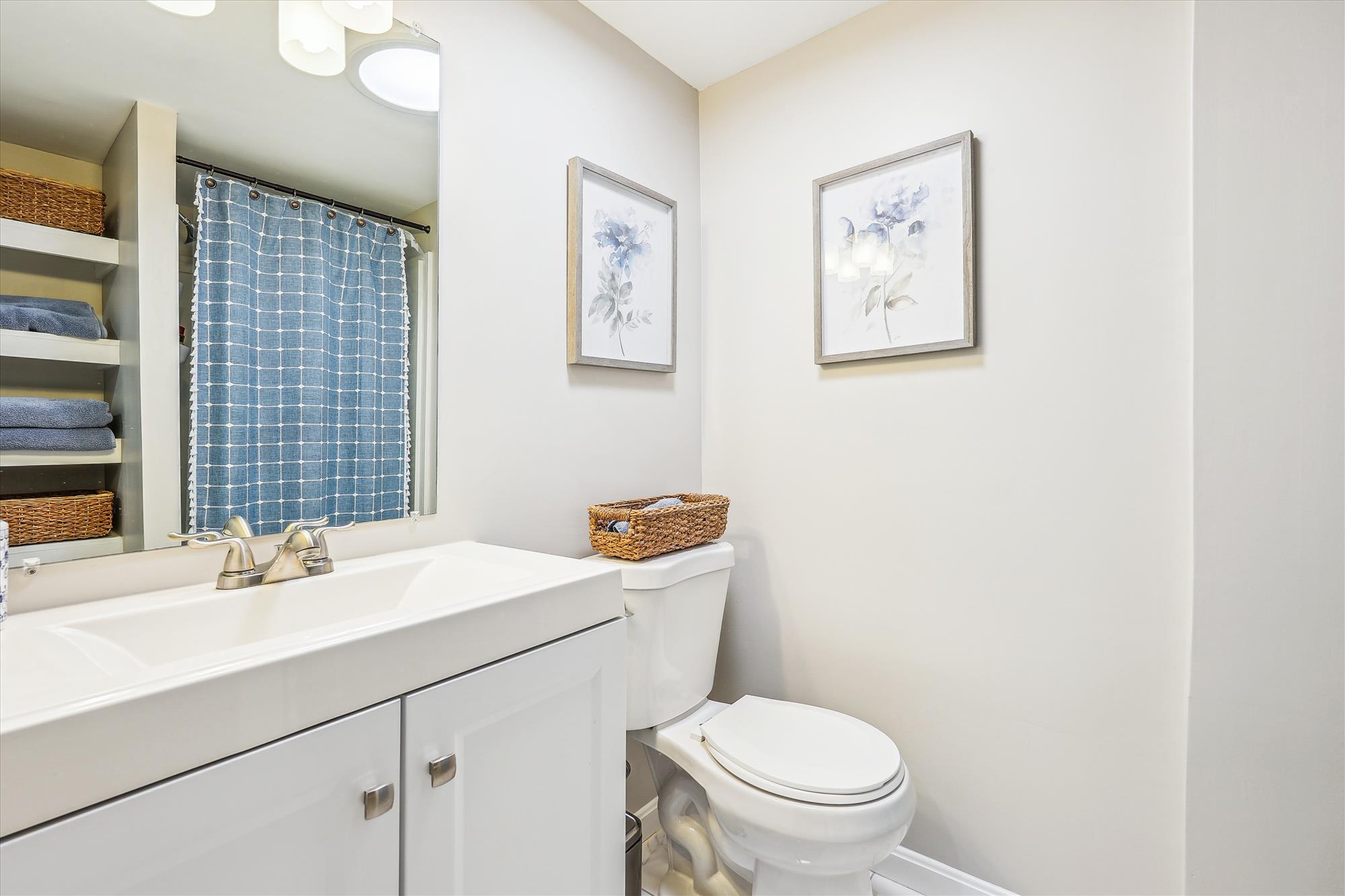 9904 Carter Road Bethesda, MD 20817 - Photo 36 of 41 a bathroom with a sink a toilet and mirror