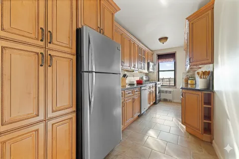 a kitchen with refrigerator and cabinets