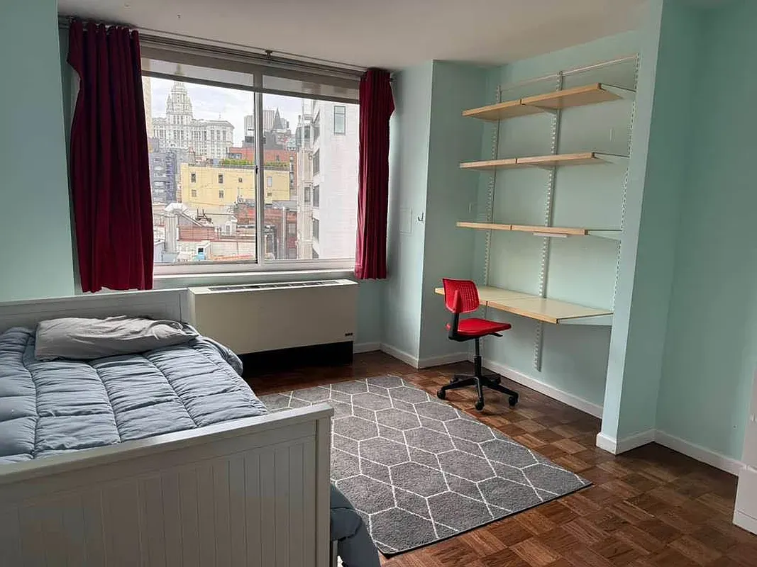 a bedroom with a bed and window