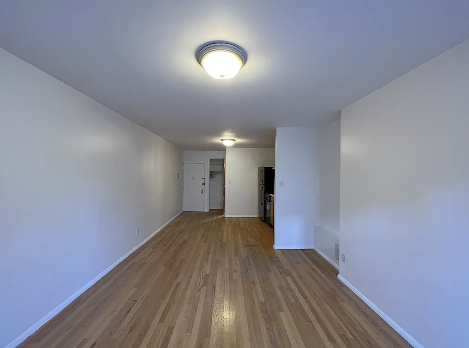 446 West 46th Street, Unit 12 Manhattan, NY 10036 - Photo 7 of 18 a view of empty room with wooden floor