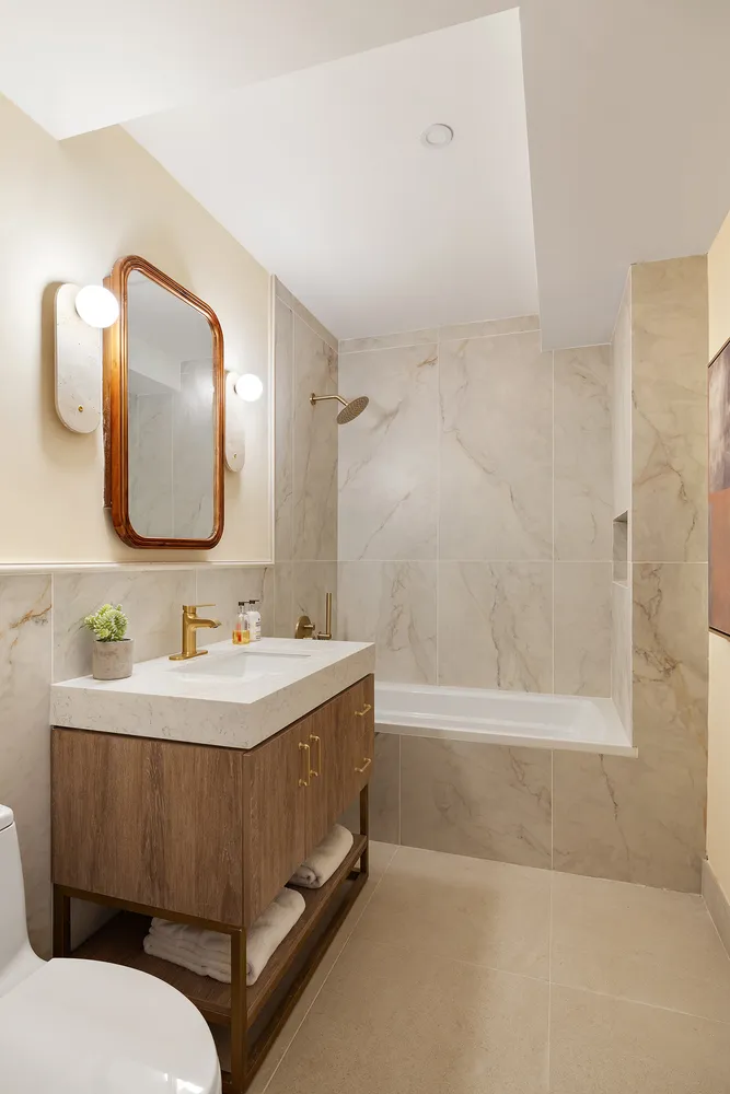a bathroom with a sink mirror and a bathtub