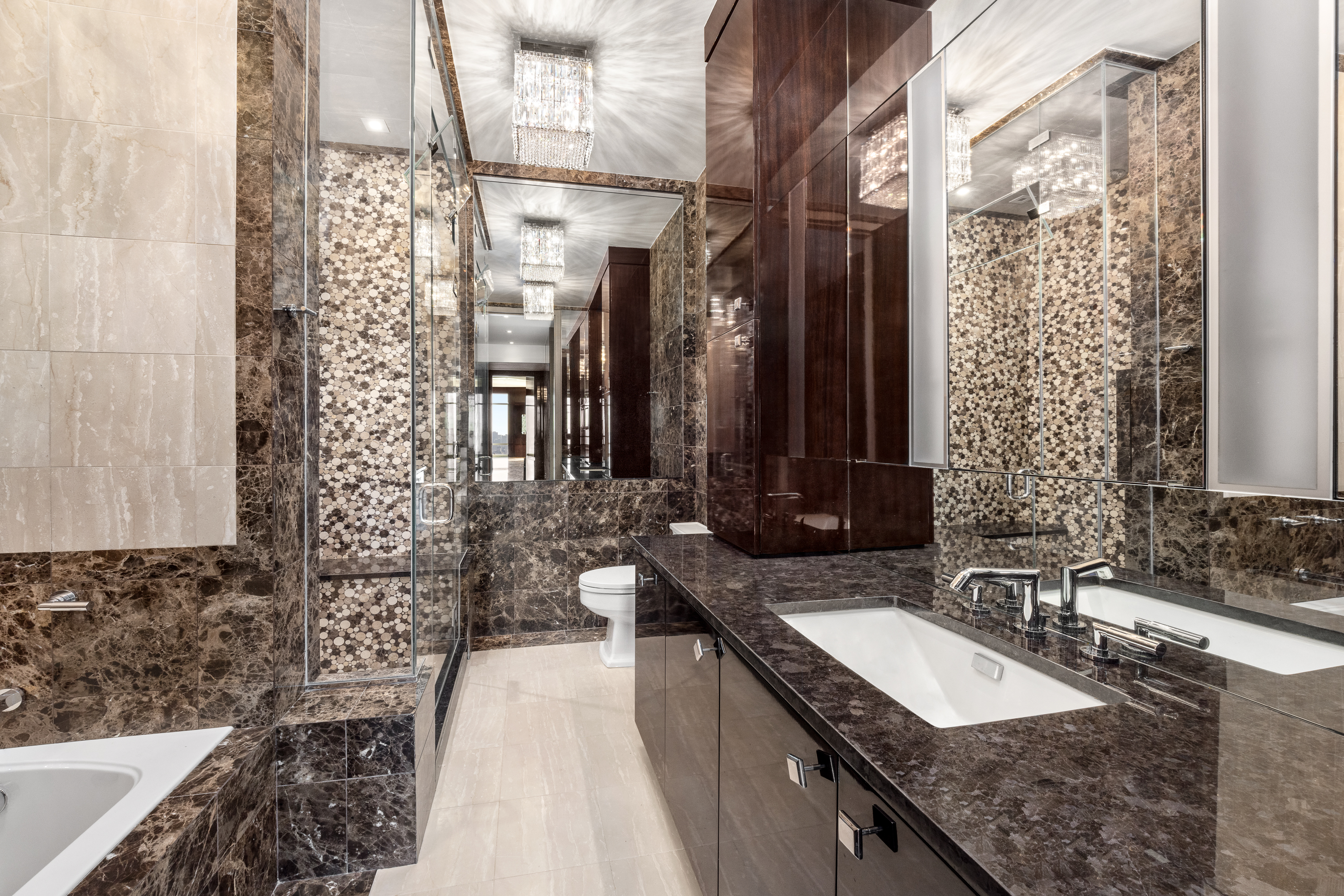 845 United Nations Plaza, Unit 86B Manhattan, NY 10017 - Photo 11 of 16 a bathroom with double vanity and a bathtub