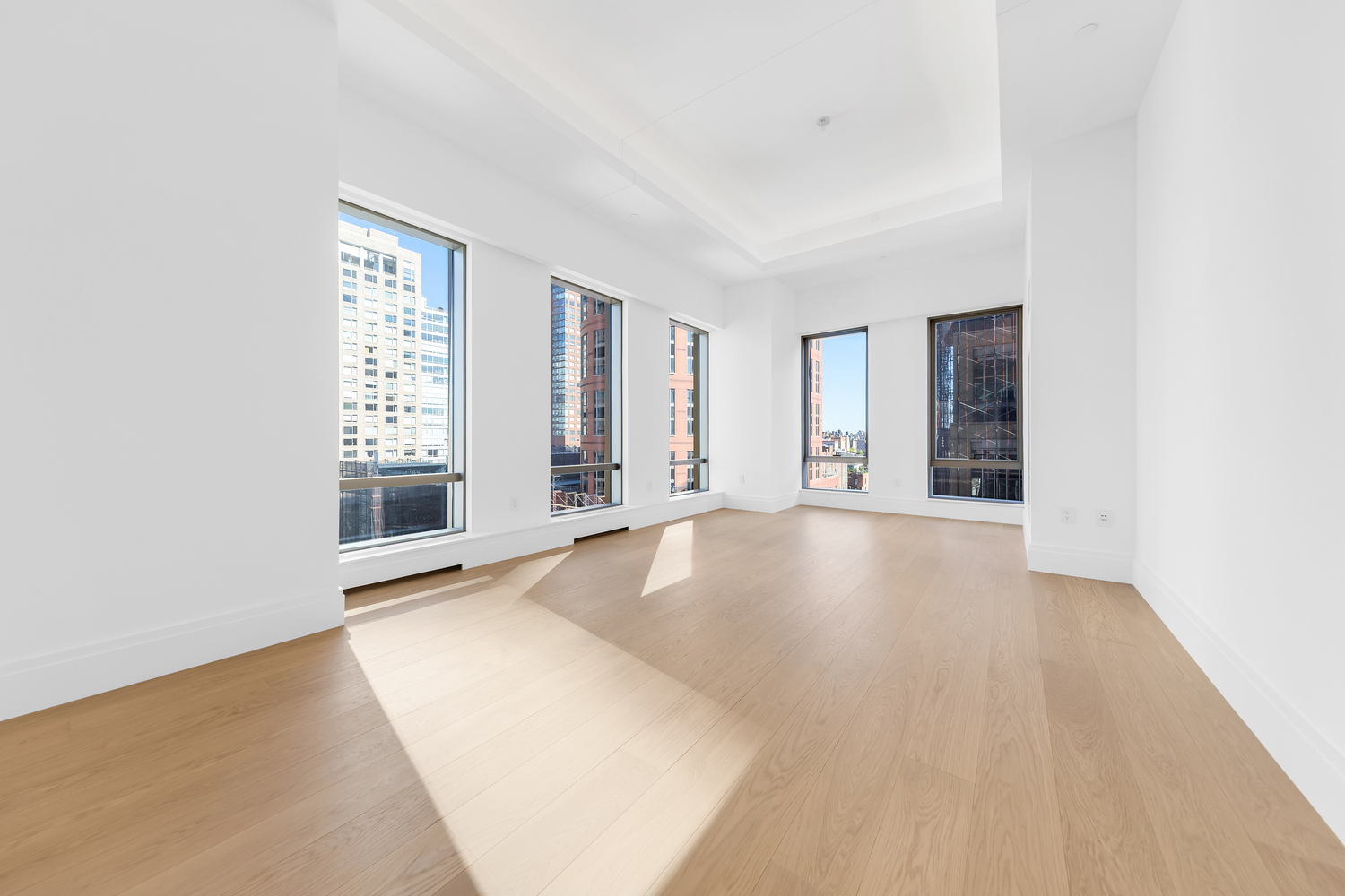 50 West 66th Street, Unit 17A Manhattan, NY 10023 - Photo 2 of 49 an empty room with windows and entrance