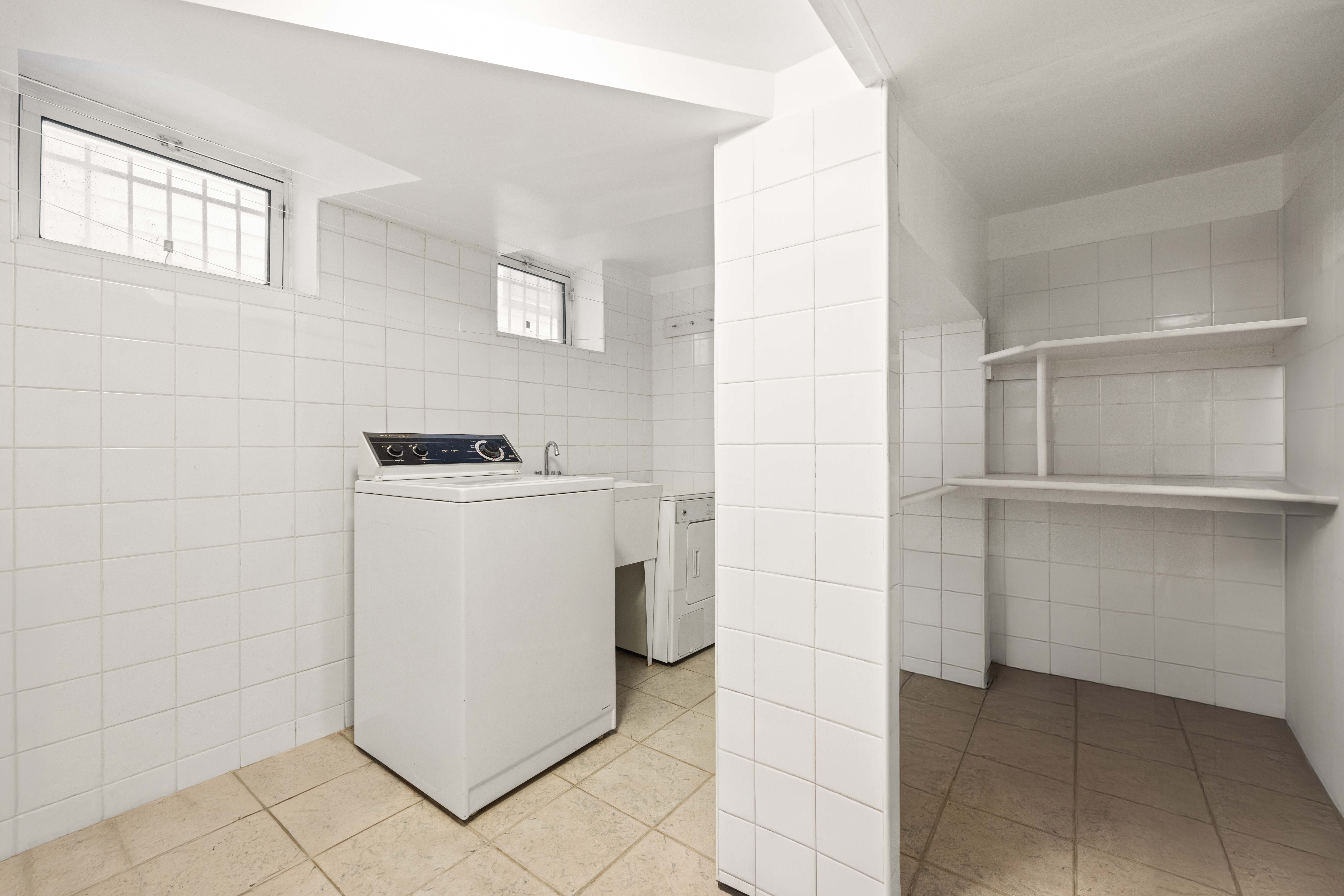 1635 West 12th Street Brooklyn, NY 11223 - Photo 19 of 21 a utility room with cabinets washer and dryer