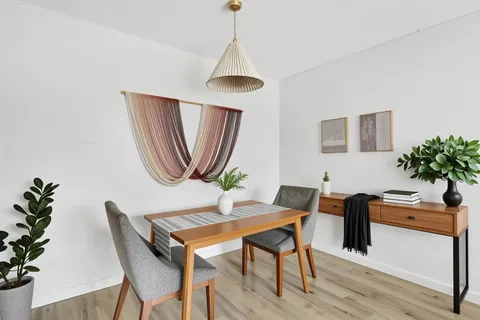 a workspace with furniture and a potted plant
