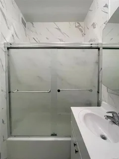 a bathroom with a sink and shower