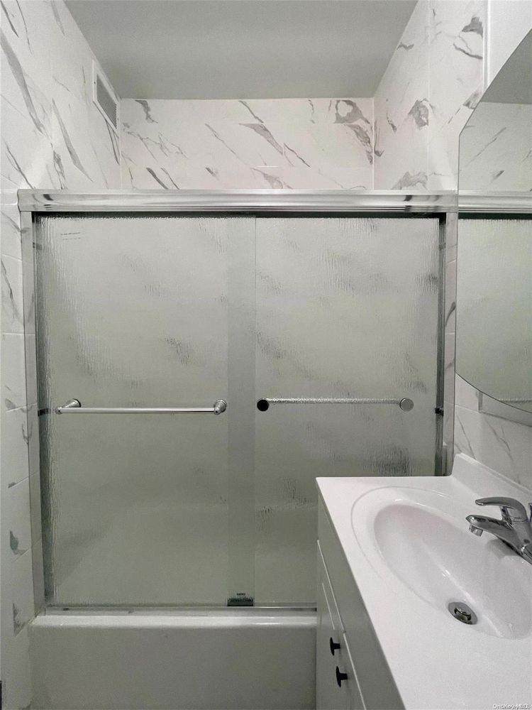 2049 2nd Avenue Manhattan, NY 10029 - Photo 12 of 18 a bathroom with a sink and shower