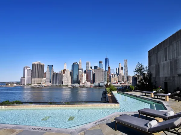 a view of a swimming pool with outdoor seating