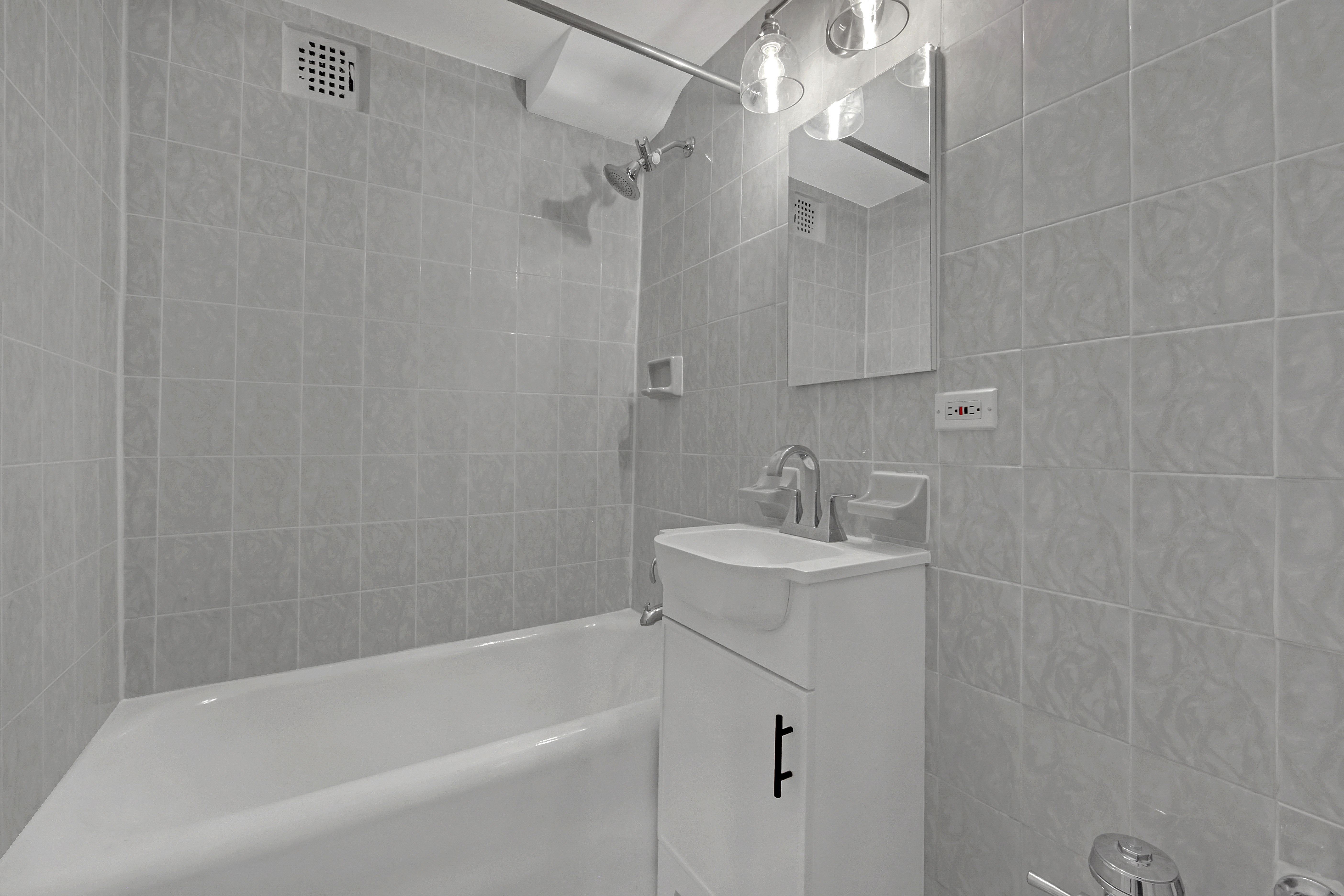 45 Tudor City Place, Unit 1902 Manhattan, NY 10017 - Photo 11 of 19 a bathroom with a sink a toilet and shower