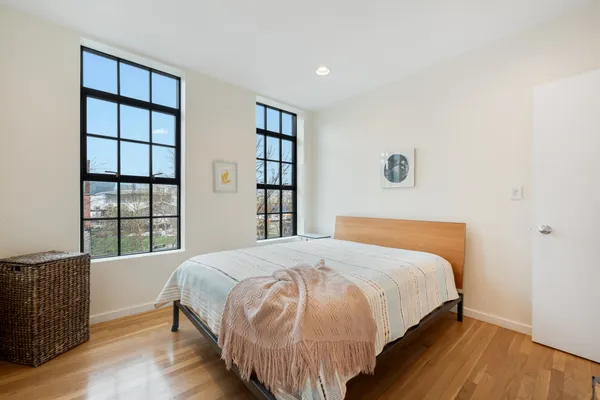a bedroom with a bed and a window
