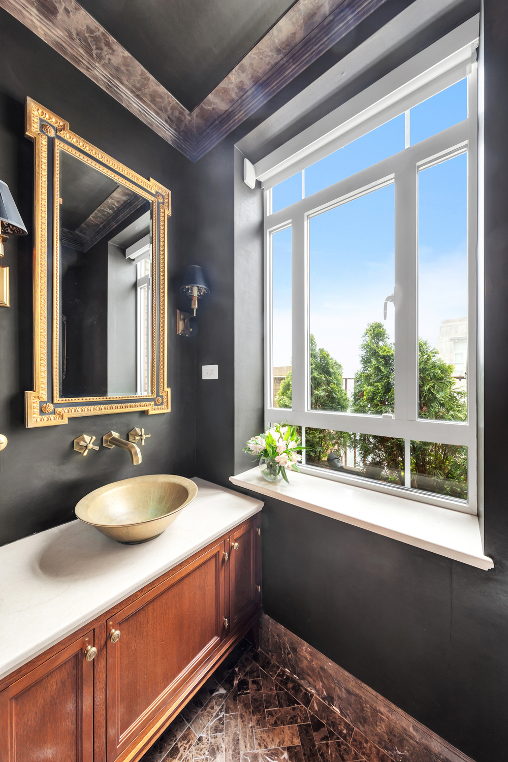 25 Central Park West, Unit 21J Manhattan, NY 10023 - Photo 21 of 37 a bathroom with a sink and a large mirror