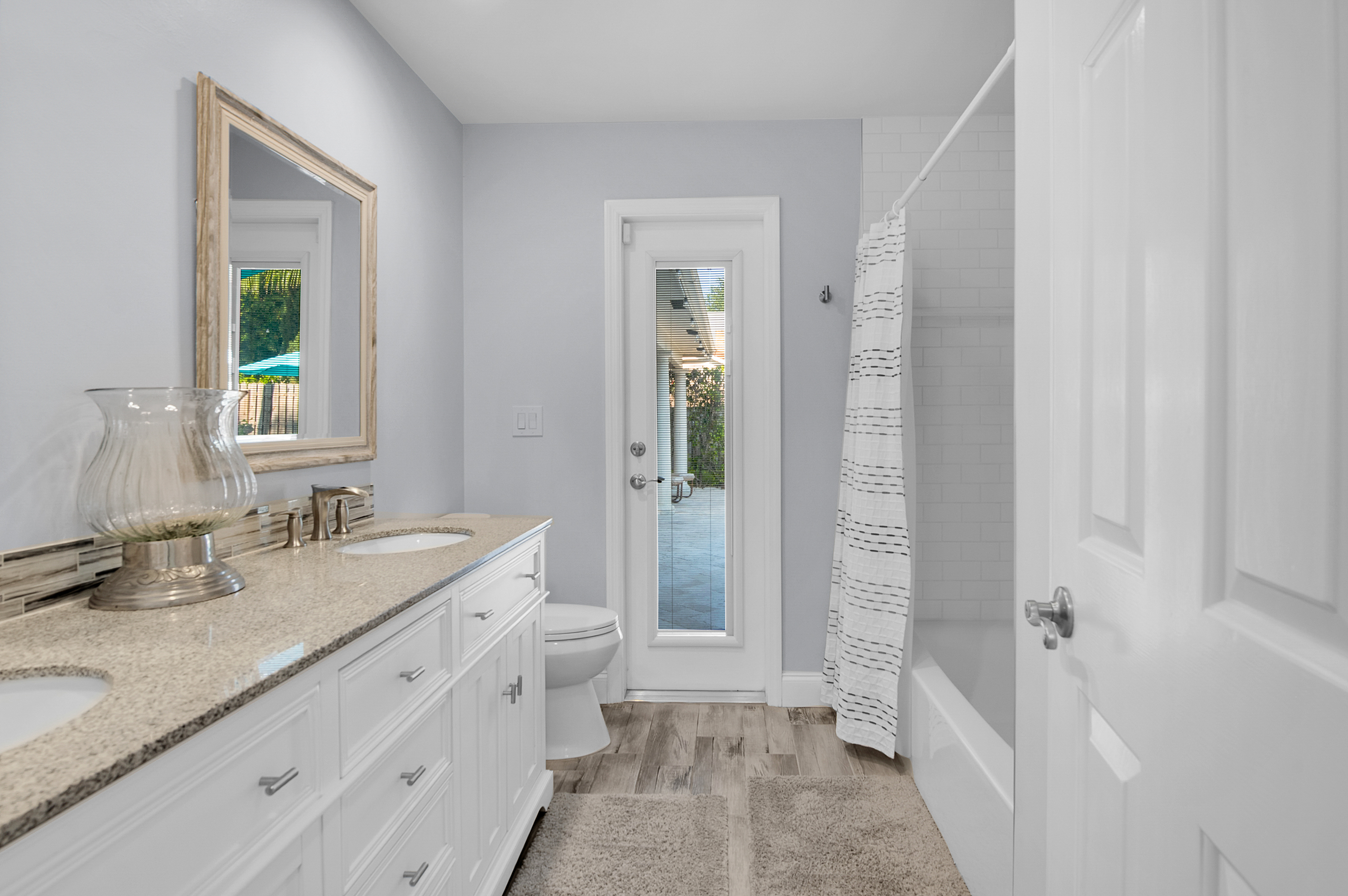1560 Southwest 16th Street Boca Raton, FL 33486 - Photo 61 of 72 a bathroom with a granite countertop sink and a mirror