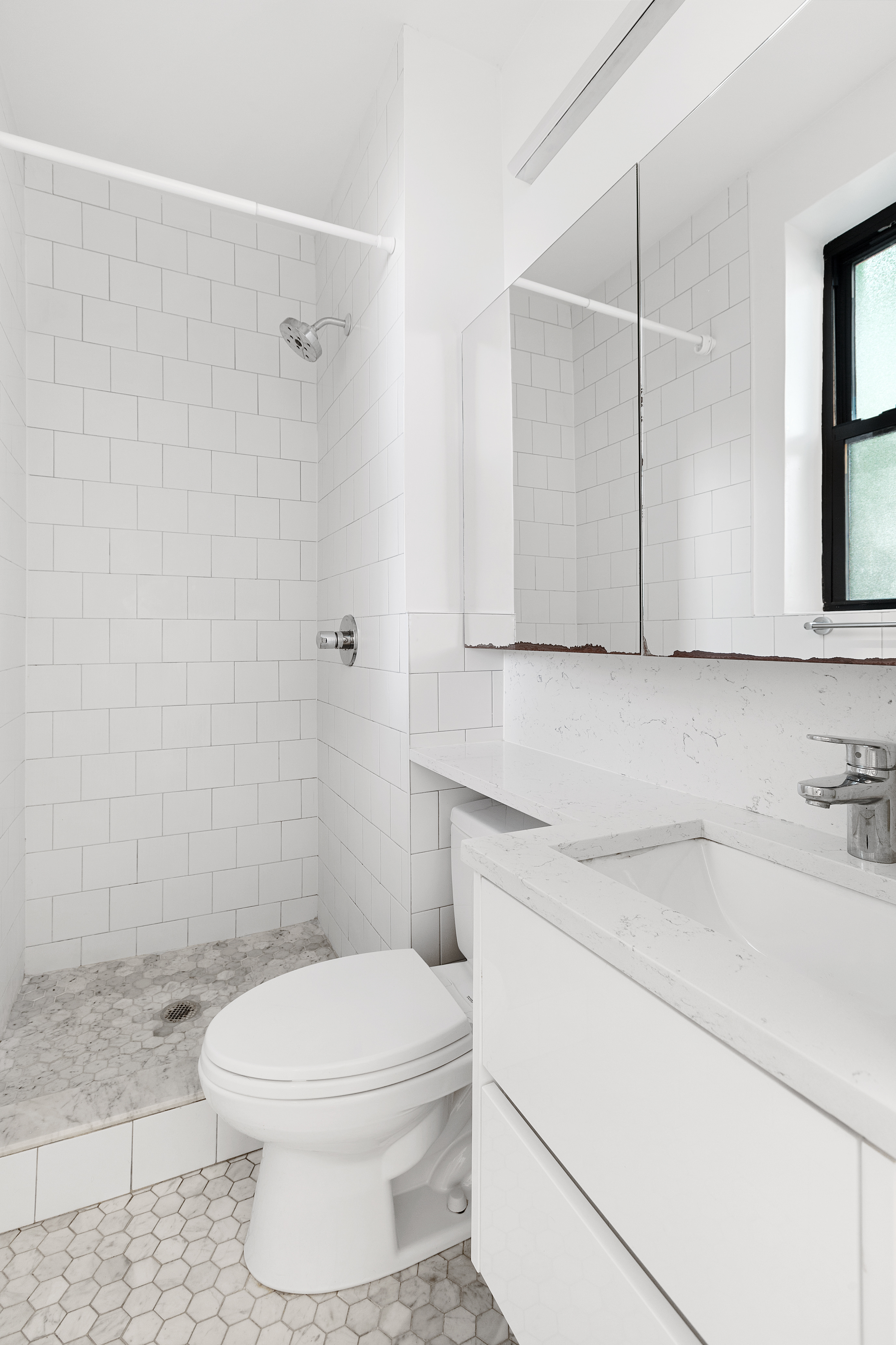 35 Clarkson Avenue, Unit A4 Brooklyn, NY 11226 - Photo 4 of 7 a bathroom with a sink a toilet and shower