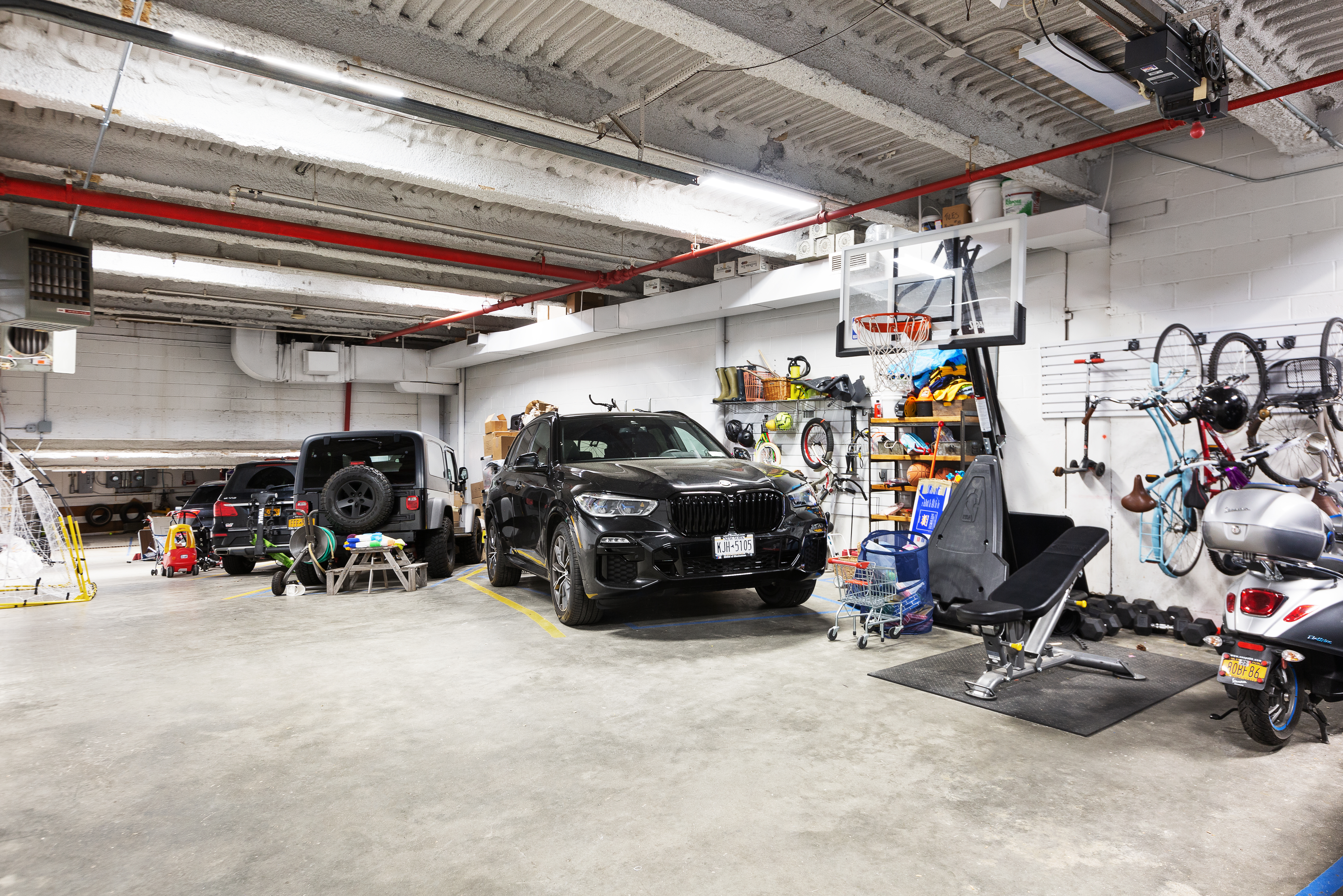 687 Greenwich Street, Unit TH7 Manhattan, NY 10014 - Photo 22 of 23 a view of a garage with a bike and car