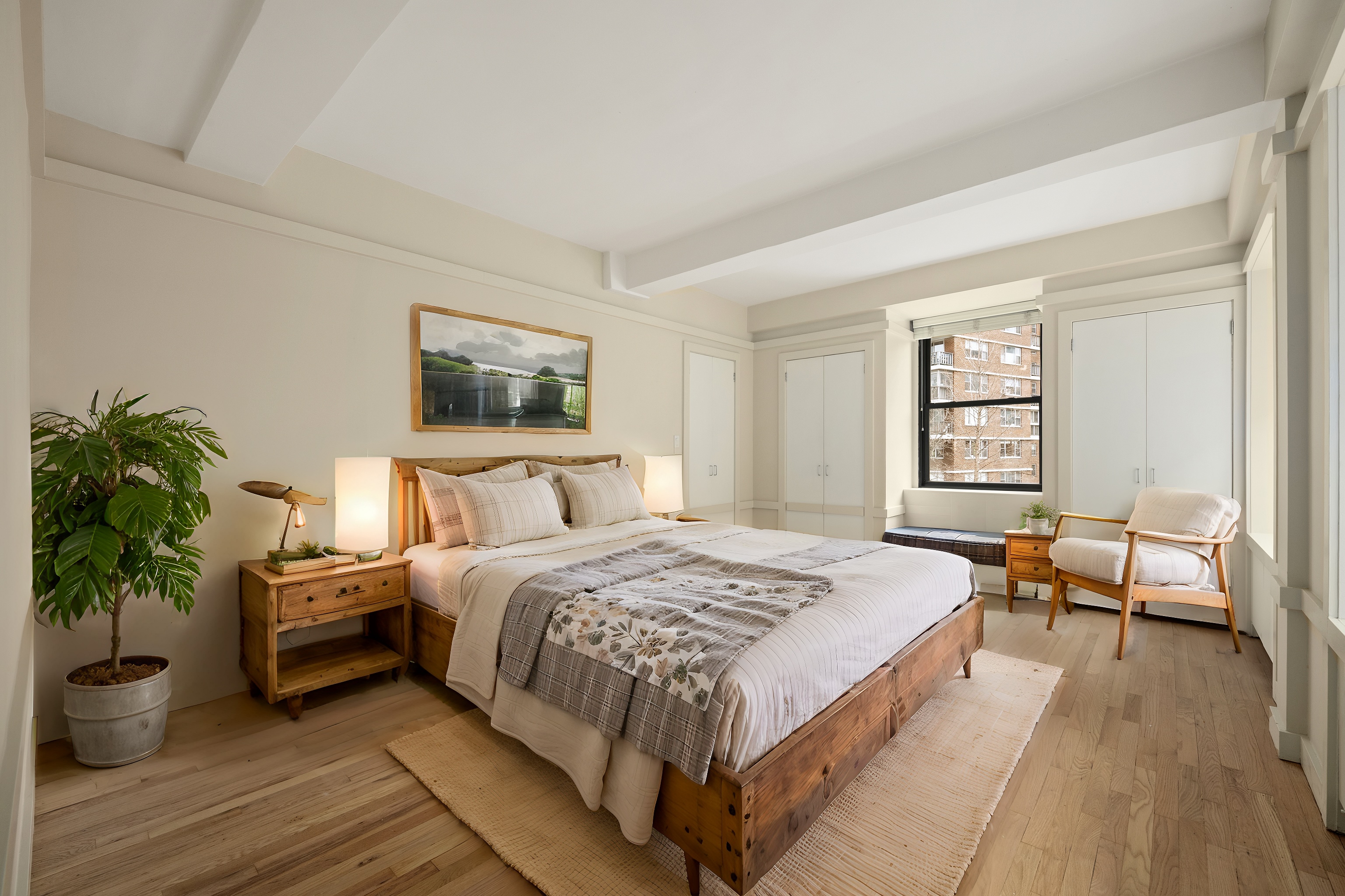 315 West 23rd Street, Unit 3E Manhattan, NY 10011 - Photo 5 of 10 a bedroom with a bed and a potted plant