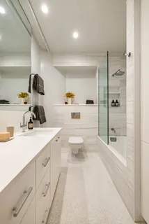a bathroom with a sink a toilet and a shower