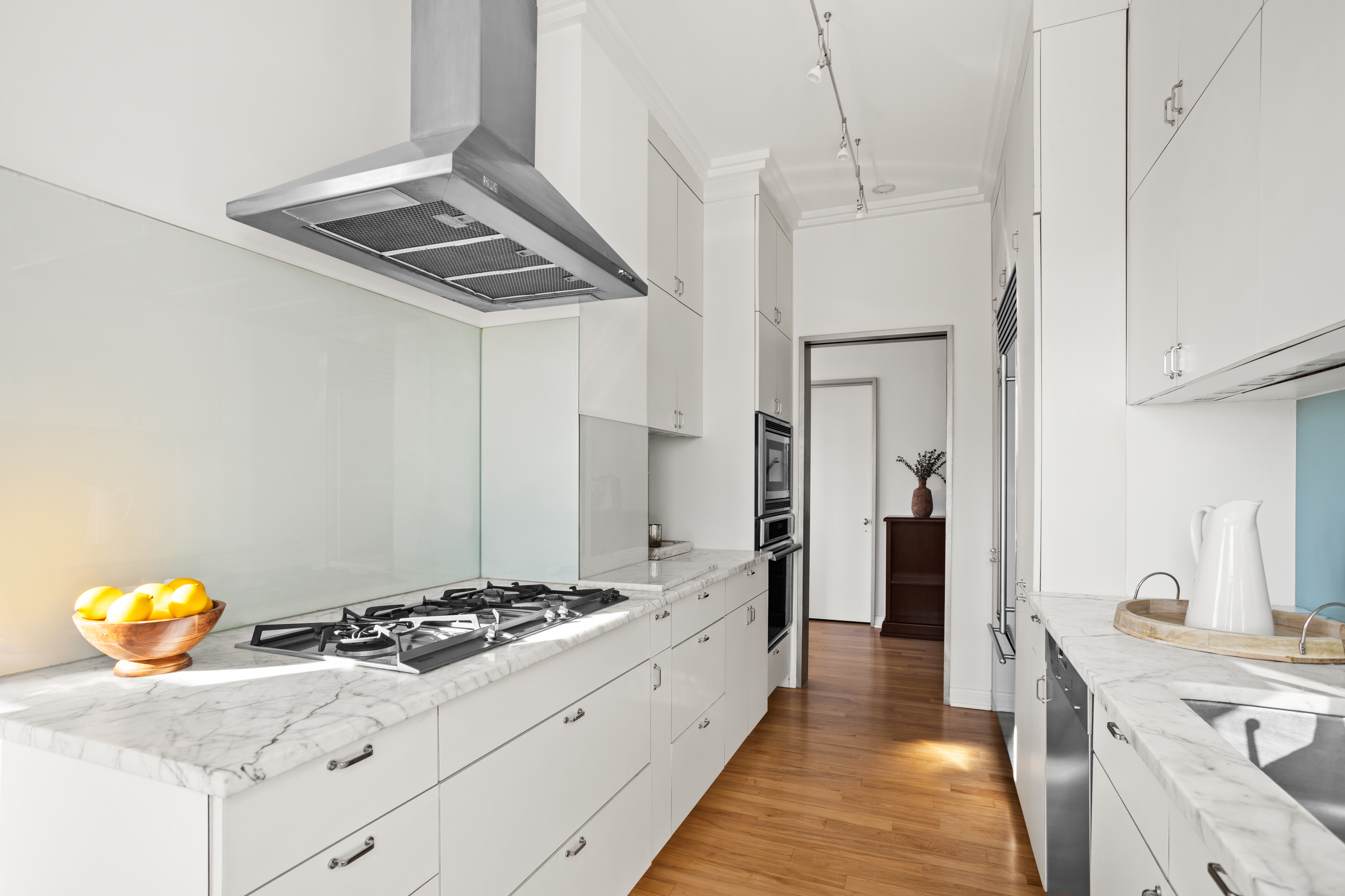 2 5th Avenue, Unit PHDF Manhattan, NY 10011 - Photo 7 of 24 a kitchen with stainless steel appliances granite countertop a stove and a refrigerator