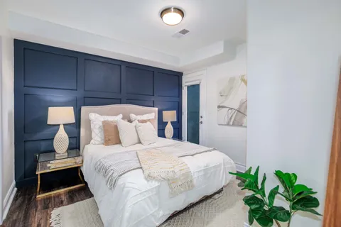 a bedroom with a bed and a potted plant