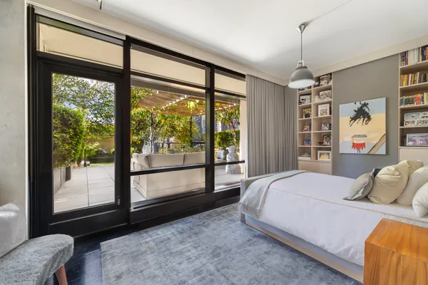 a bedroom with a large bed and a large window