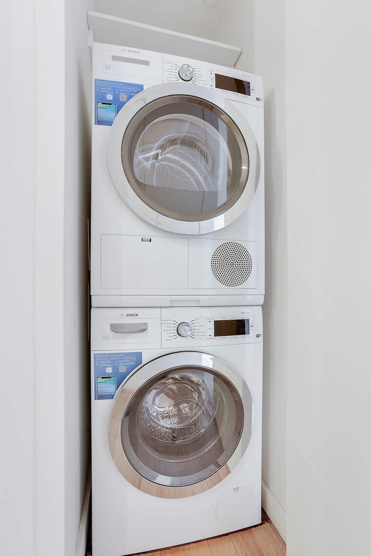 133 West 22nd Street, Unit 7H Manhattan, NY 10011 - Photo 12 of 21 a utility room with dryer and washer