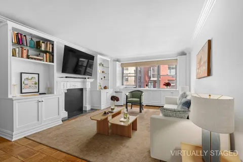 a living room with furniture fireplace and flat screen tv