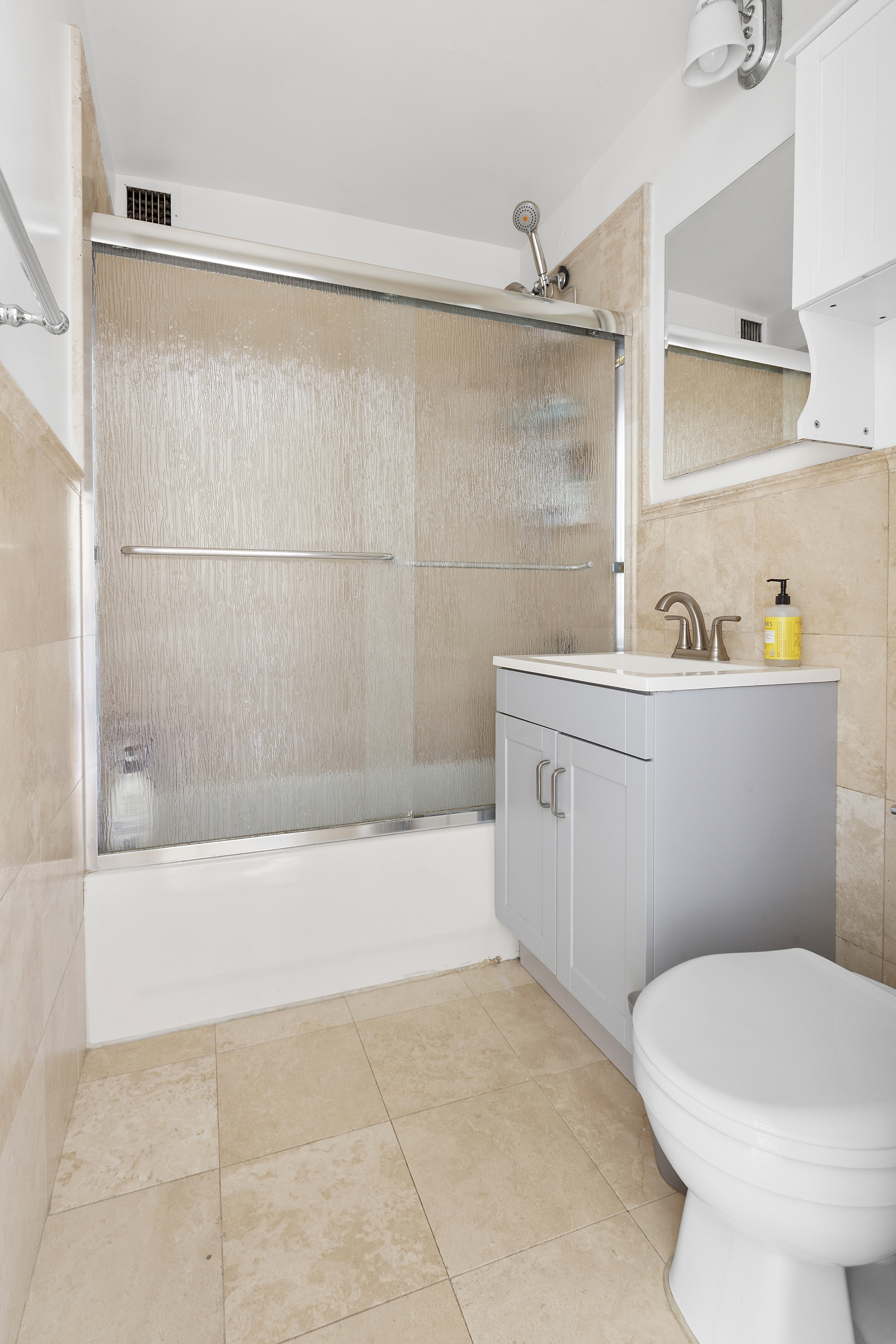 333 East 34th Street, Unit 14J Manhattan, NY 10016 - Photo 8 of 10 a bathroom with a sink a toilet and shower