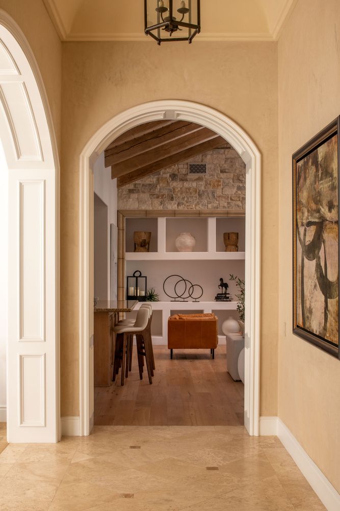 a living room with furniture large windows and a flat screen tv