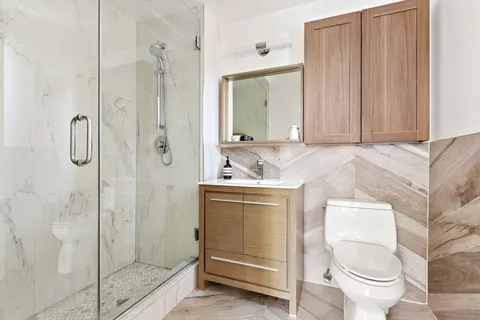 a bathroom with a sink toilet and shower