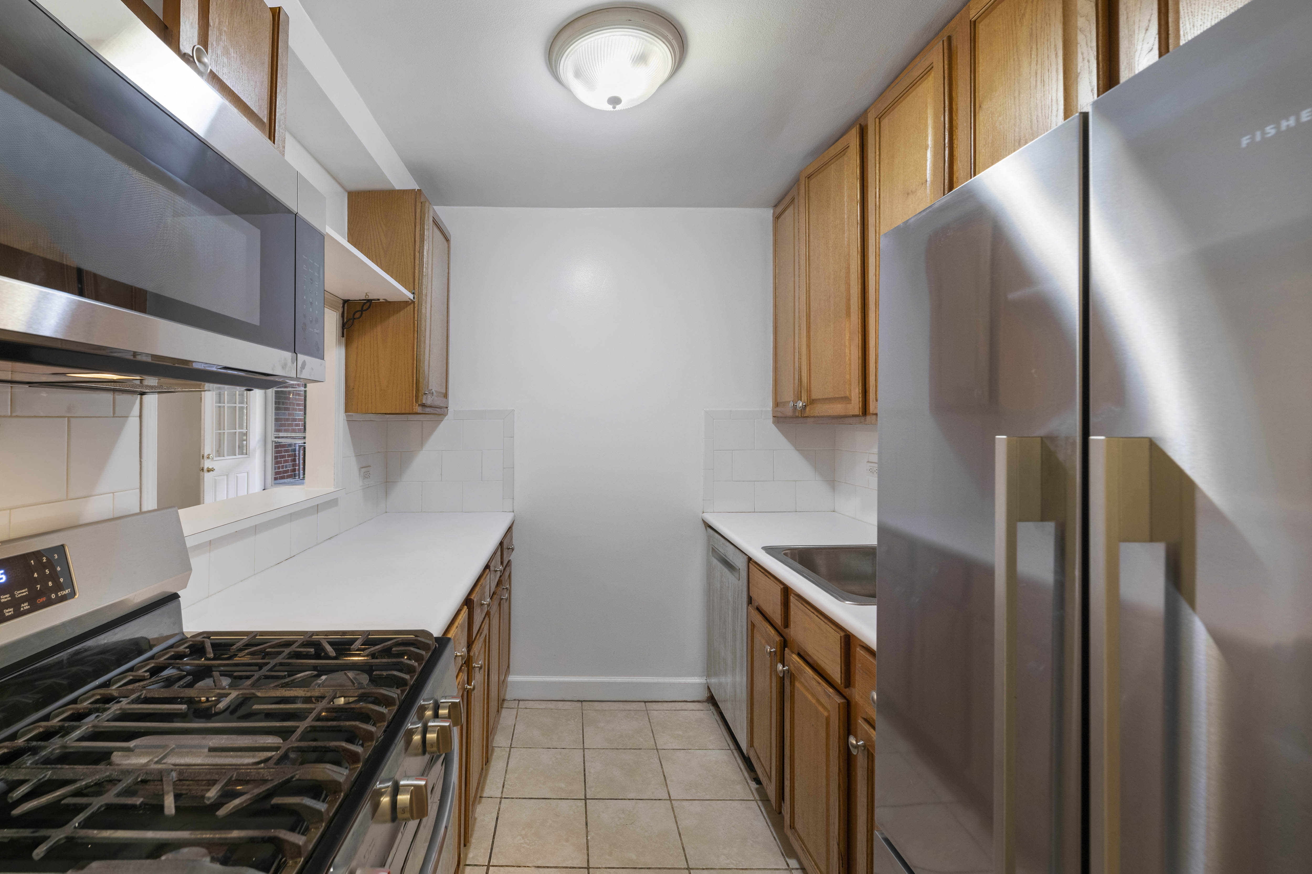 2750 Johnson Avenue, Unit 7G Bronx, NY 10463 - Photo 3 of 12 a kitchen with stainless steel appliances granite countertop a refrigerator and a stove