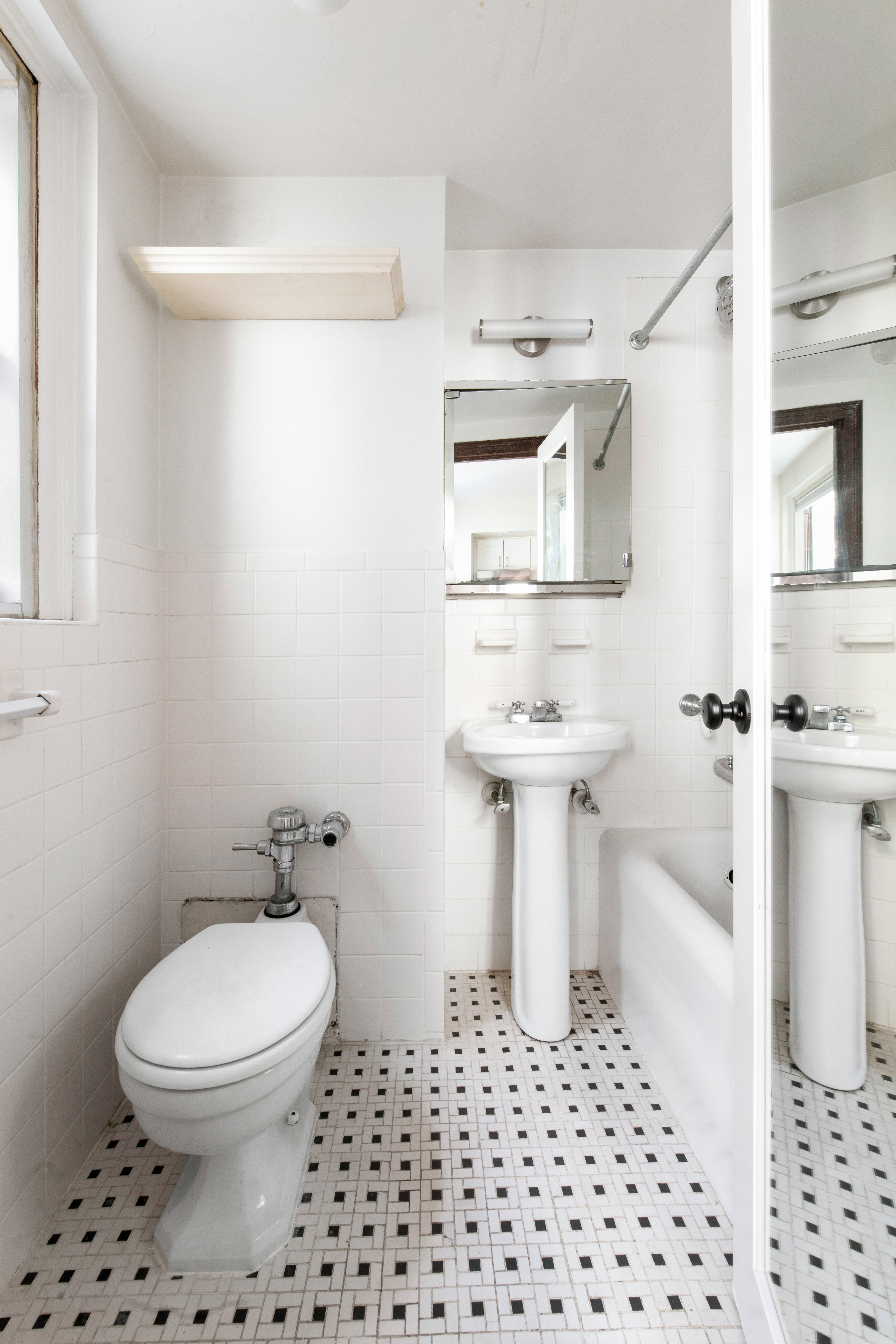 321 East 43rd Street, Unit 510 Manhattan, NY 10017 - Photo 4 of 8 a bathroom with a sink toilet and shower
