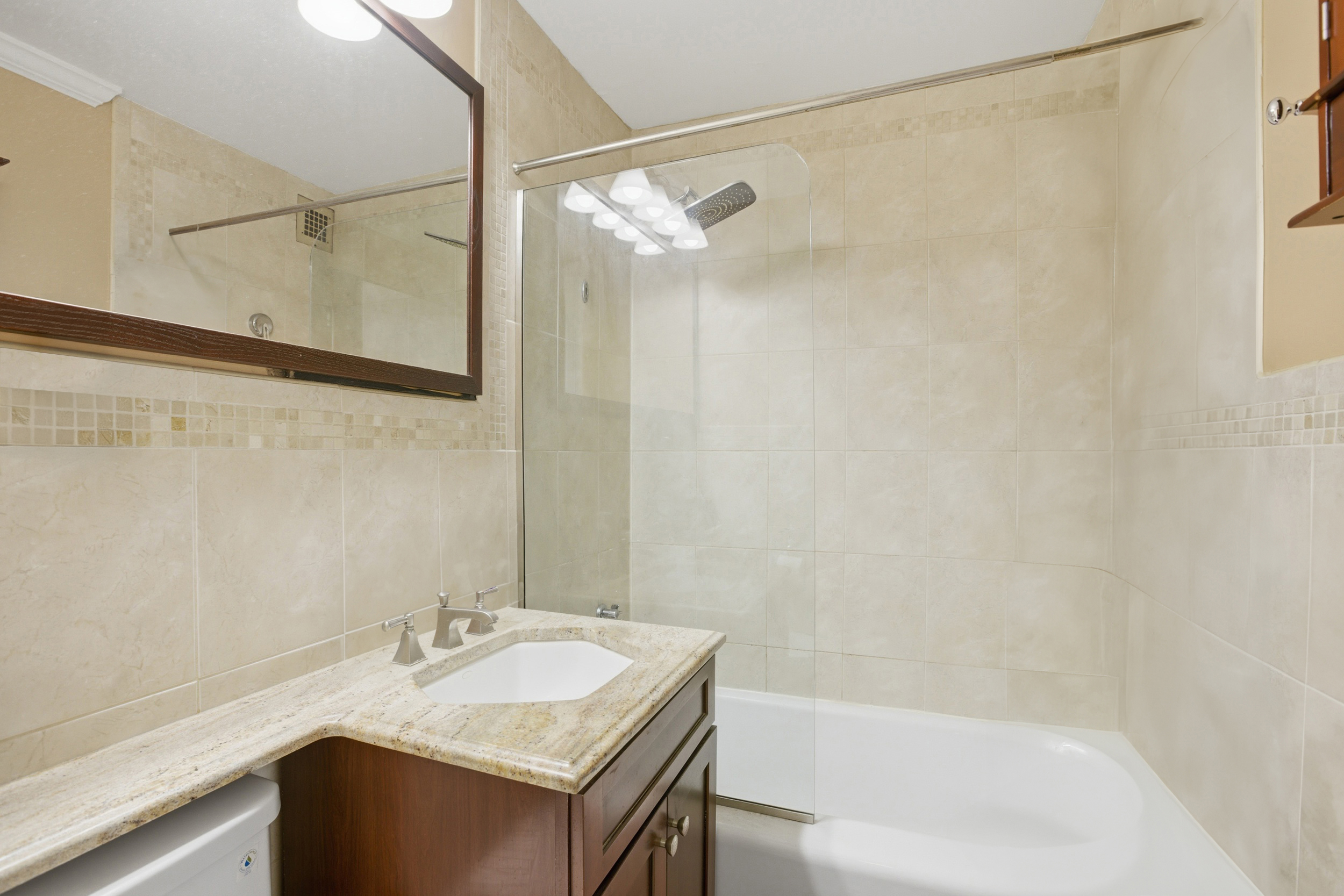 345 East 81st Street, Unit 8G Manhattan, NY 10028 - Photo 7 of 17 a bathroom with a sink and a mirror