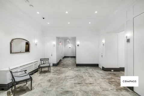 a view of a hallway with seating area