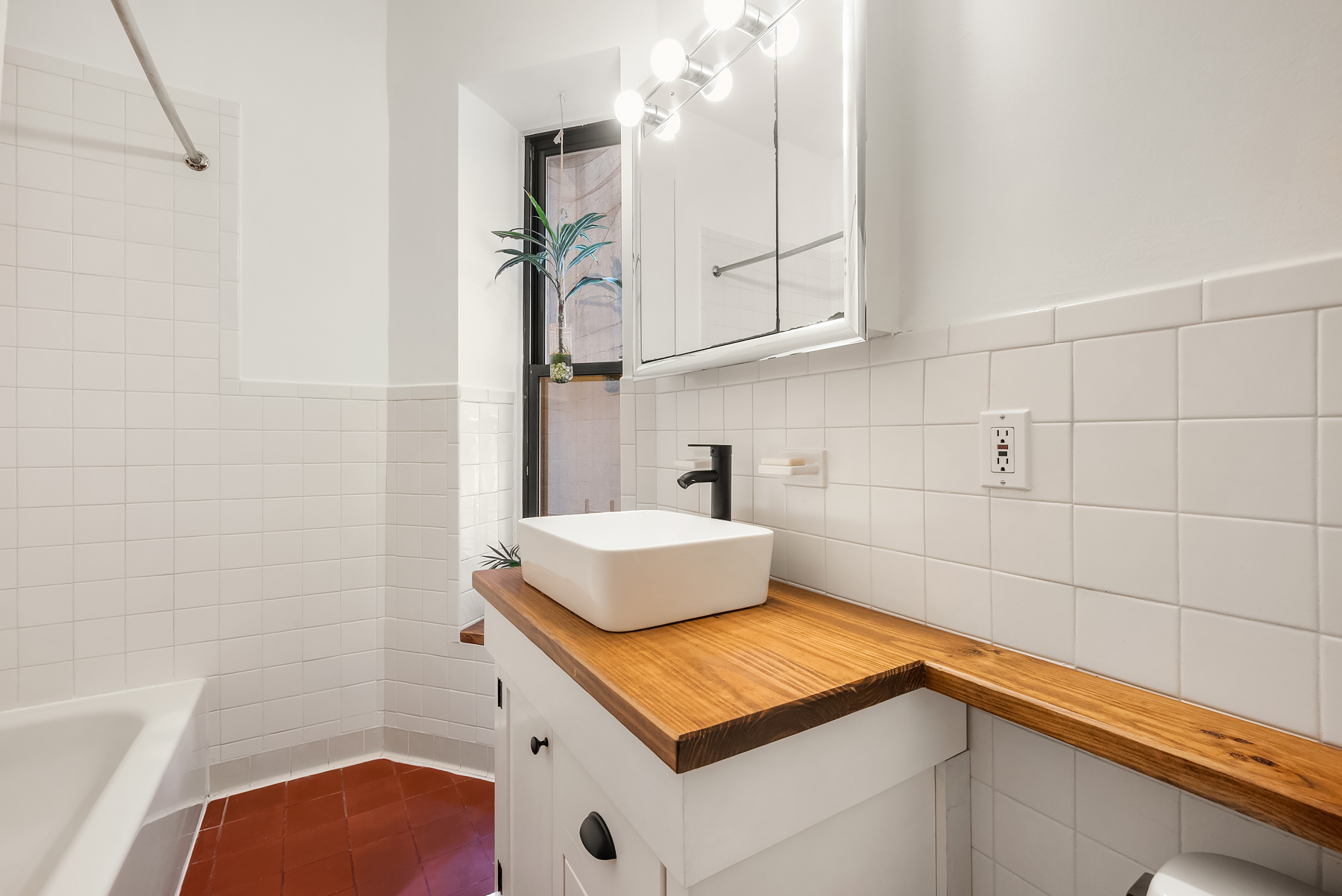 41 Perry Street, Unit 2A Manhattan, NY 10014 - Photo 8 of 12 a bathroom with a sink and a mirror