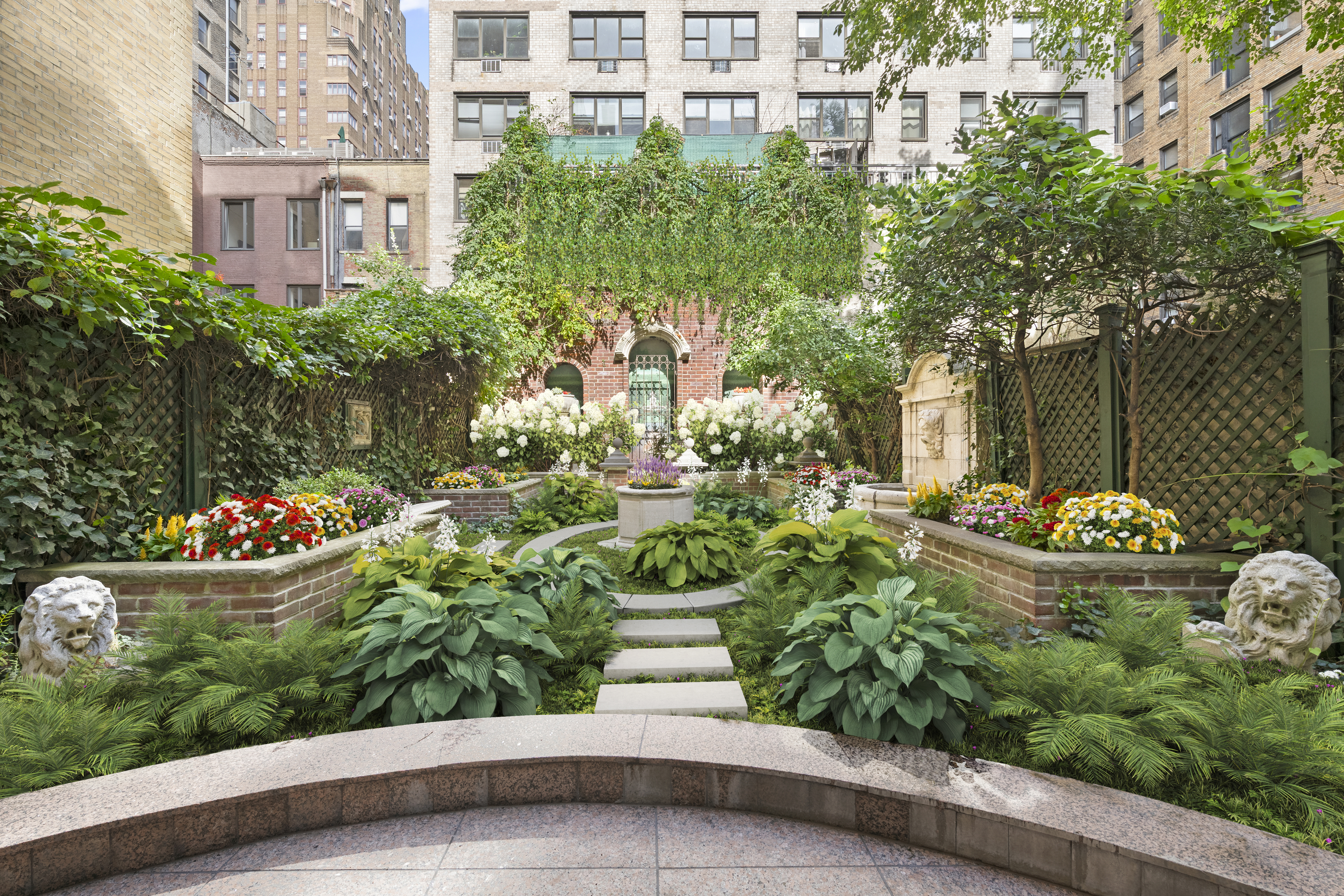 a front view of a house with a yard and fountain