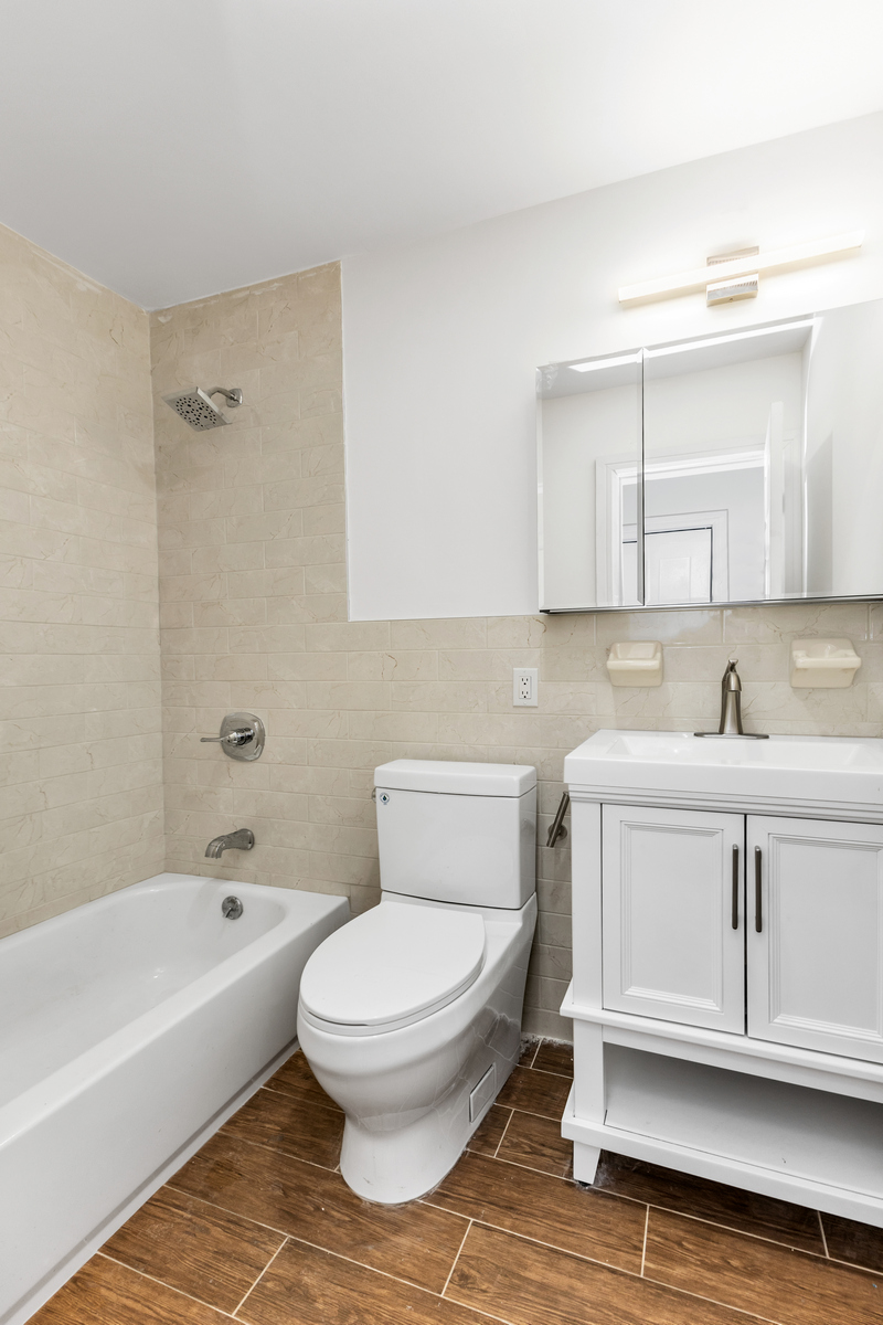 574 Gates Avenue Brooklyn, NY 11221 - Photo 15 of 16 a bathroom with a sink a toilet and bathtub