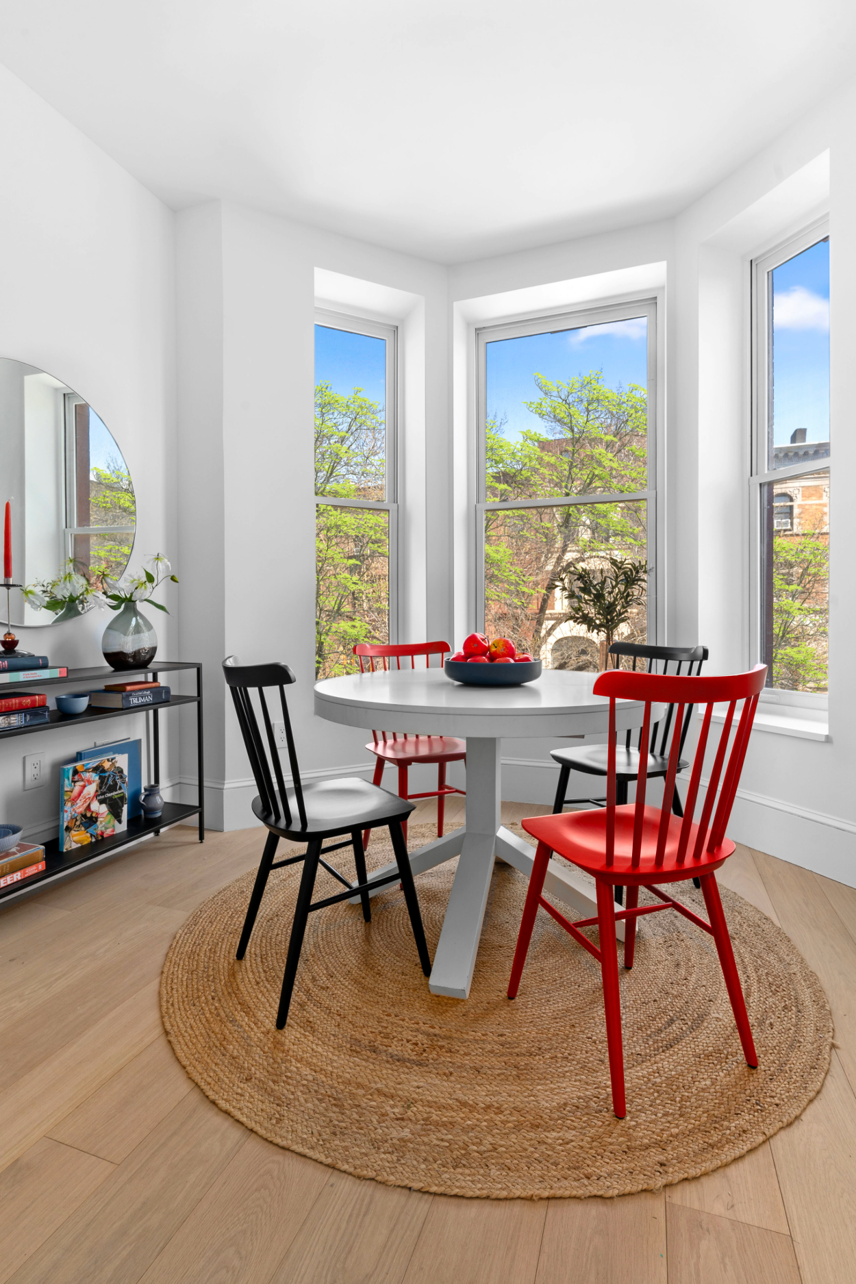 a view of a dining room with furniture a rug and a large window